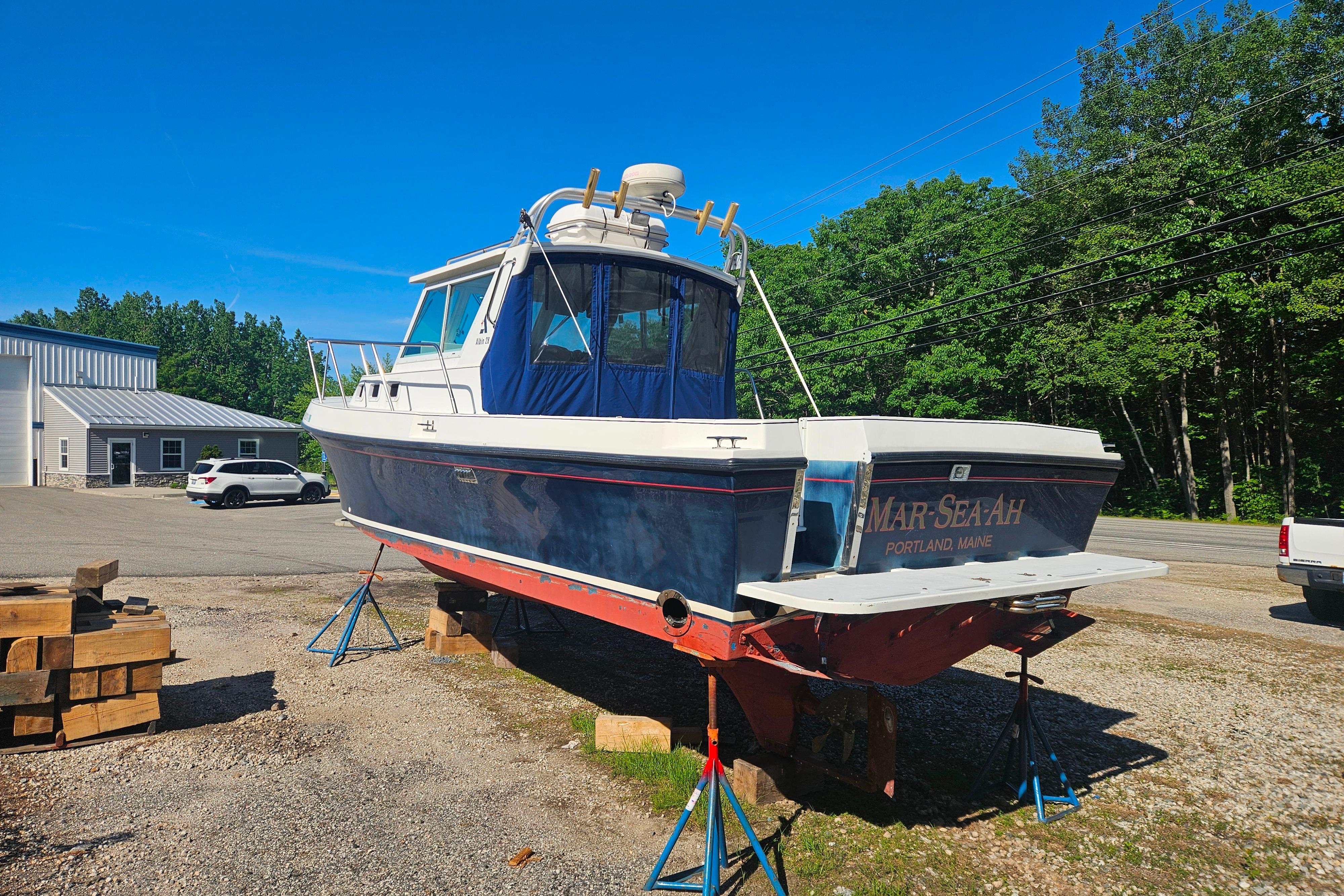 1999 Albin 28 Tournament Express boat on stands, Portland, Maine, sunny day.