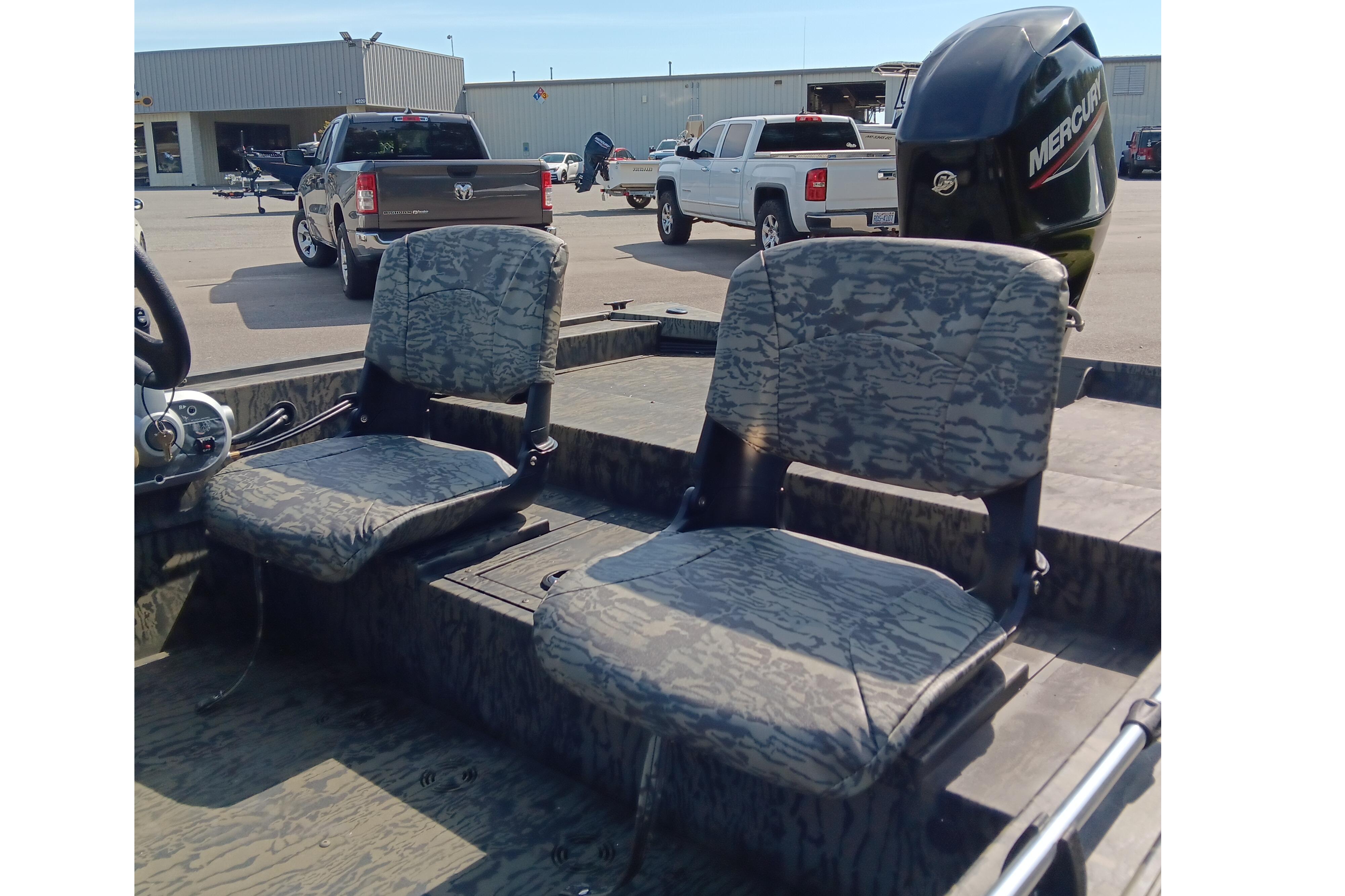 2026 Tracker Grizzly 1754 SC boat interior with camo seats and Mercury outboard motor.