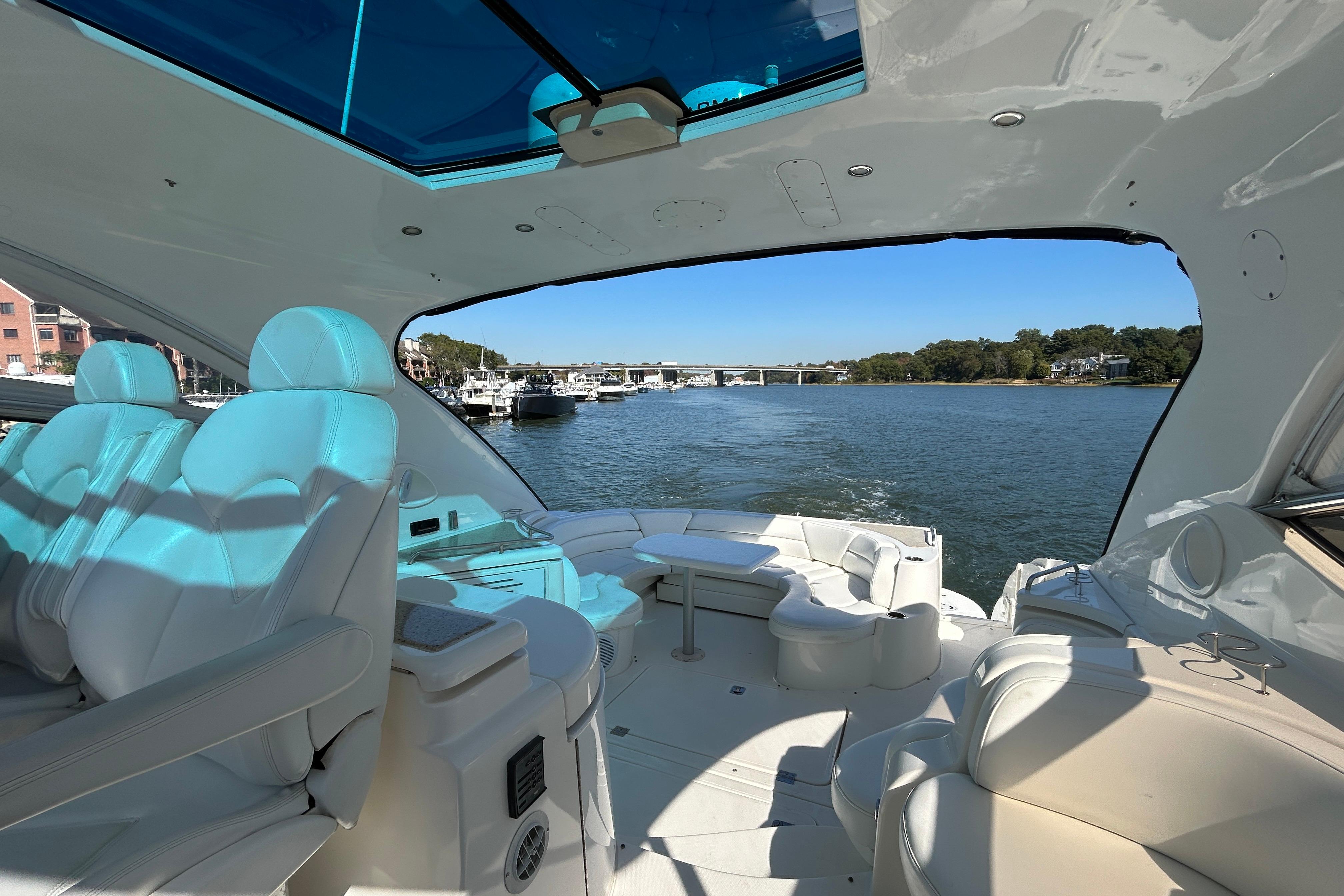 2003 Cruisers Yachts 540 Express interior with luxurious seating and scenic water view.