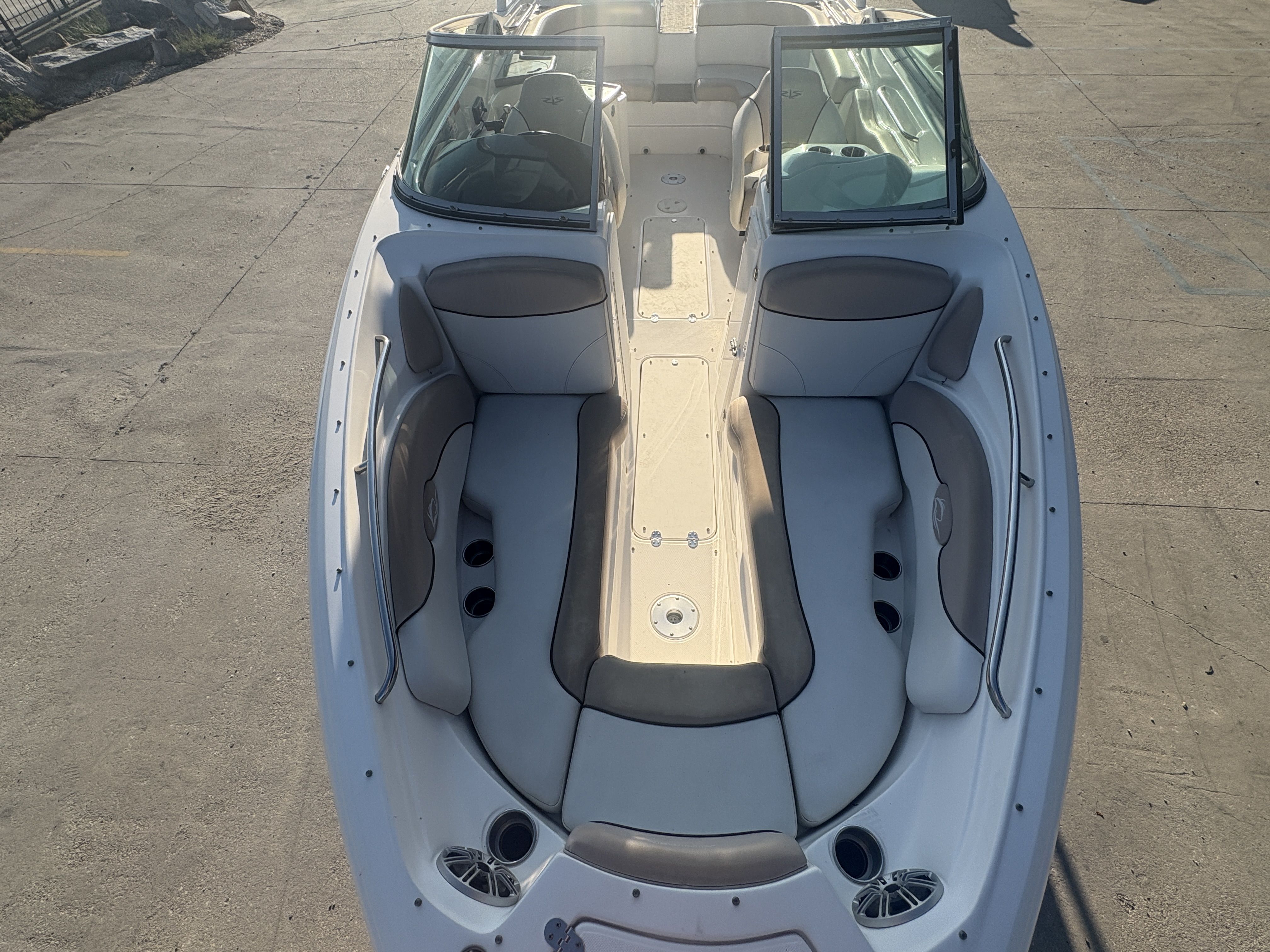 2013 Rinker Captiva 276 boat with spacious seating and open deck layout.
