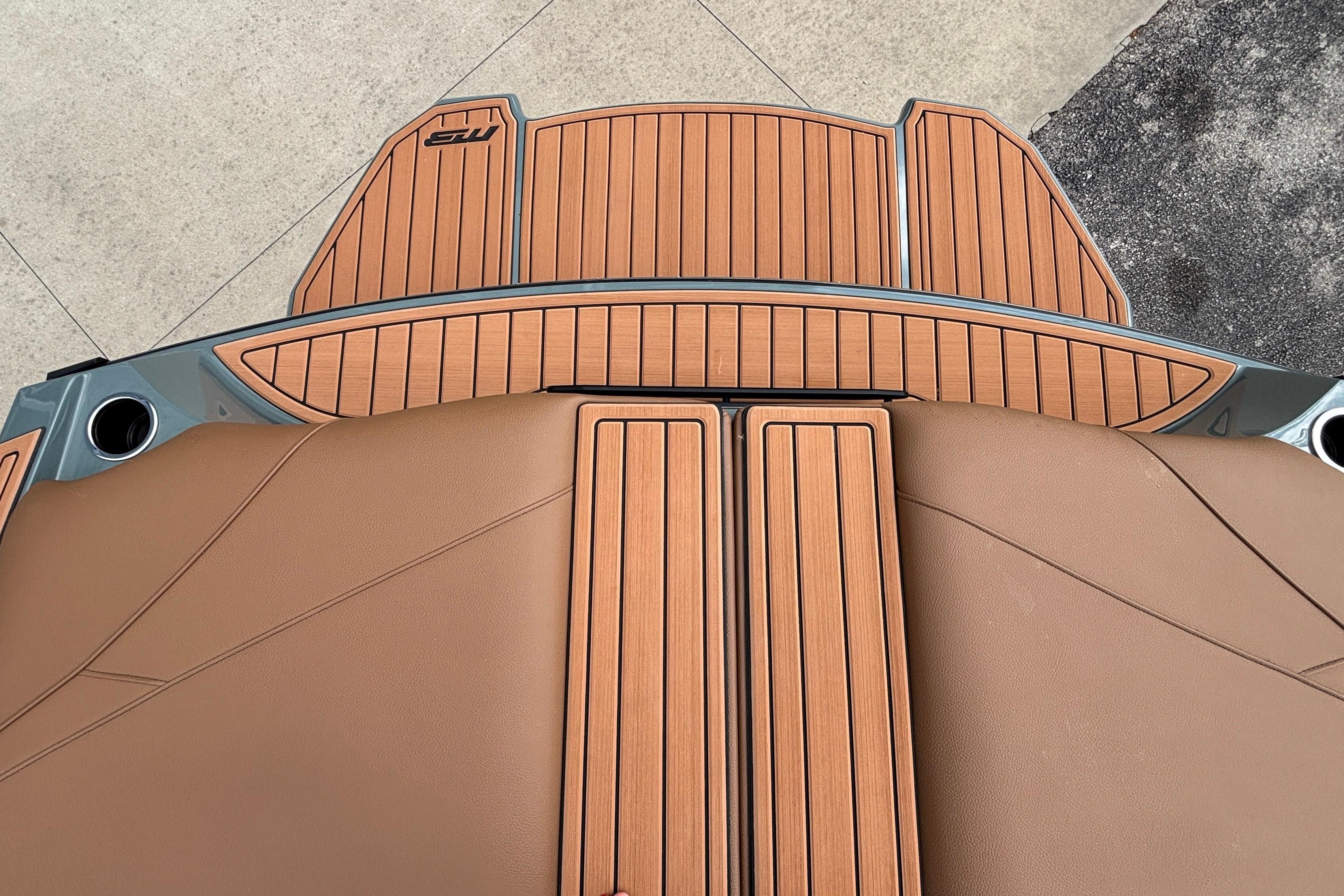 2026 MB B52 23 Classic boat deck with sleek brown and wood finish.
