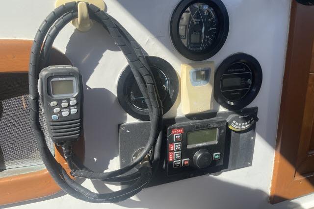 Control panel of a 1982 Formosa 42 sailboat with gauges and radio equipment.