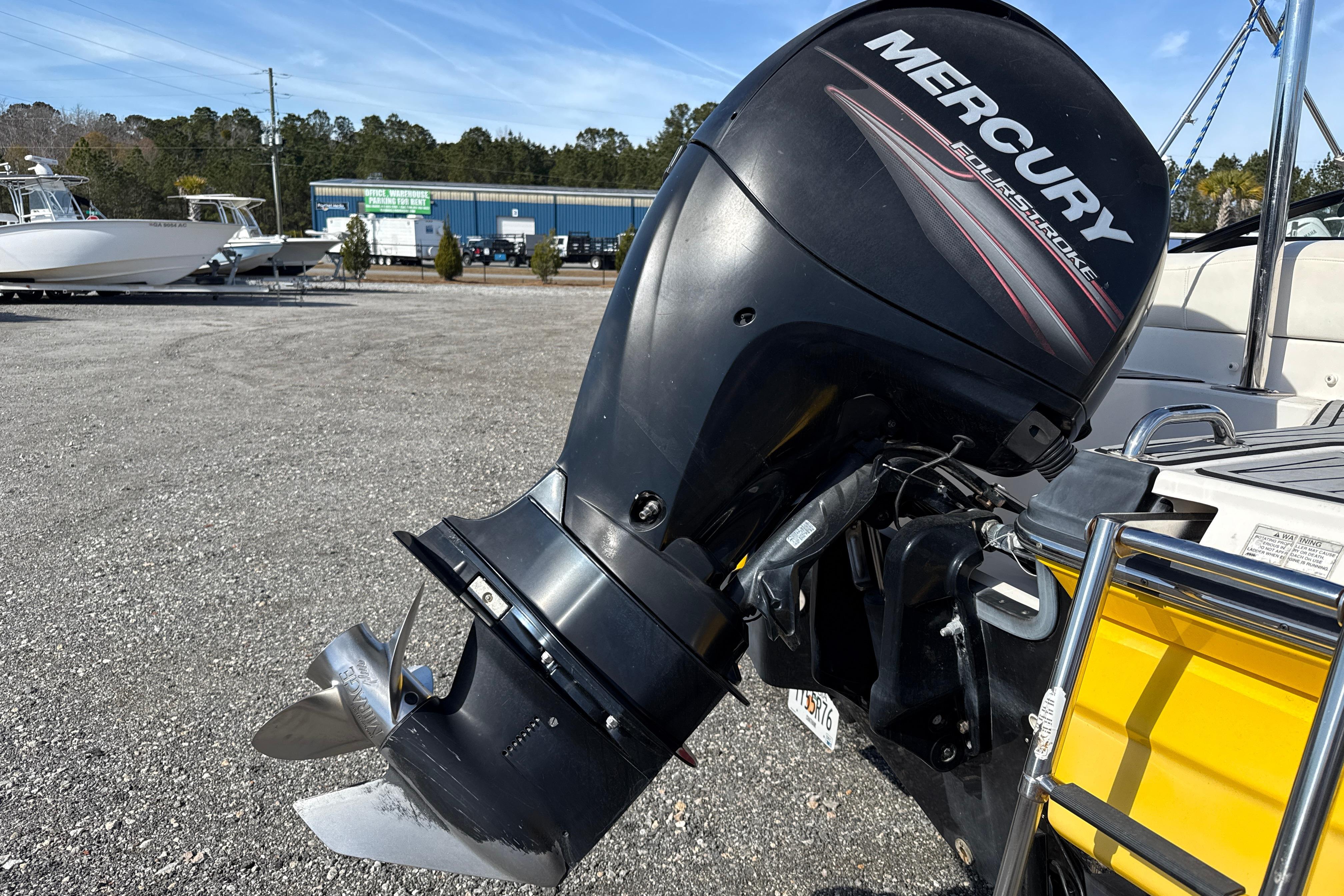 Outboard motor on a 2014 Monterey 197 Blackfin boat in a marina setting.