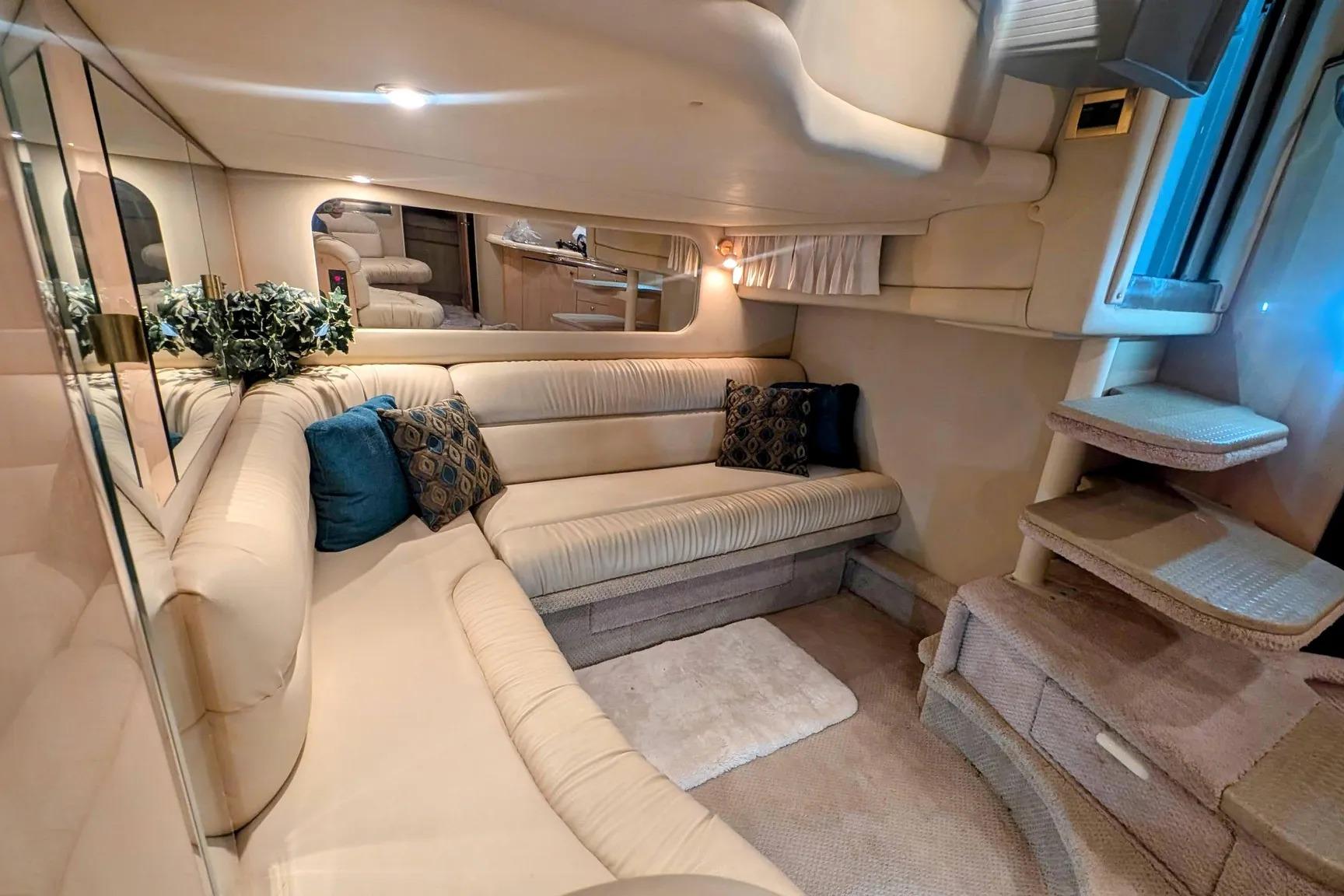 Luxurious interior of 2000 Sea Ray 380 Sundancer yacht with plush seating and elegant decor.