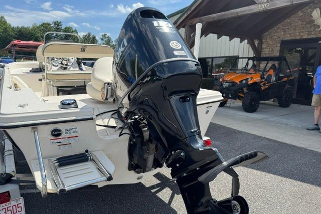 2023 Carolina Skiff 192 JLS boat with powerful outboard motor, parked outdoors.