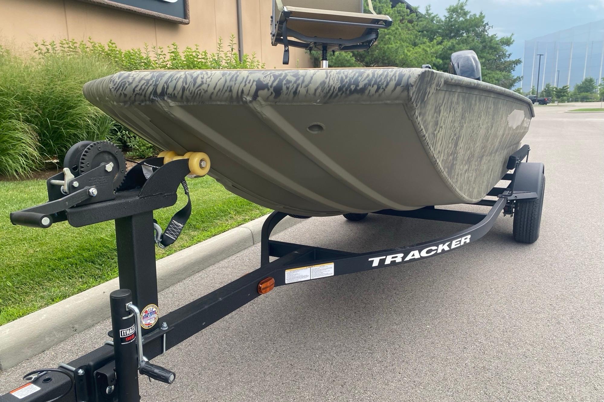 2026 Tracker Grizzly 1650 T Prairie Wings Edition boat on trailer, parked outdoors.