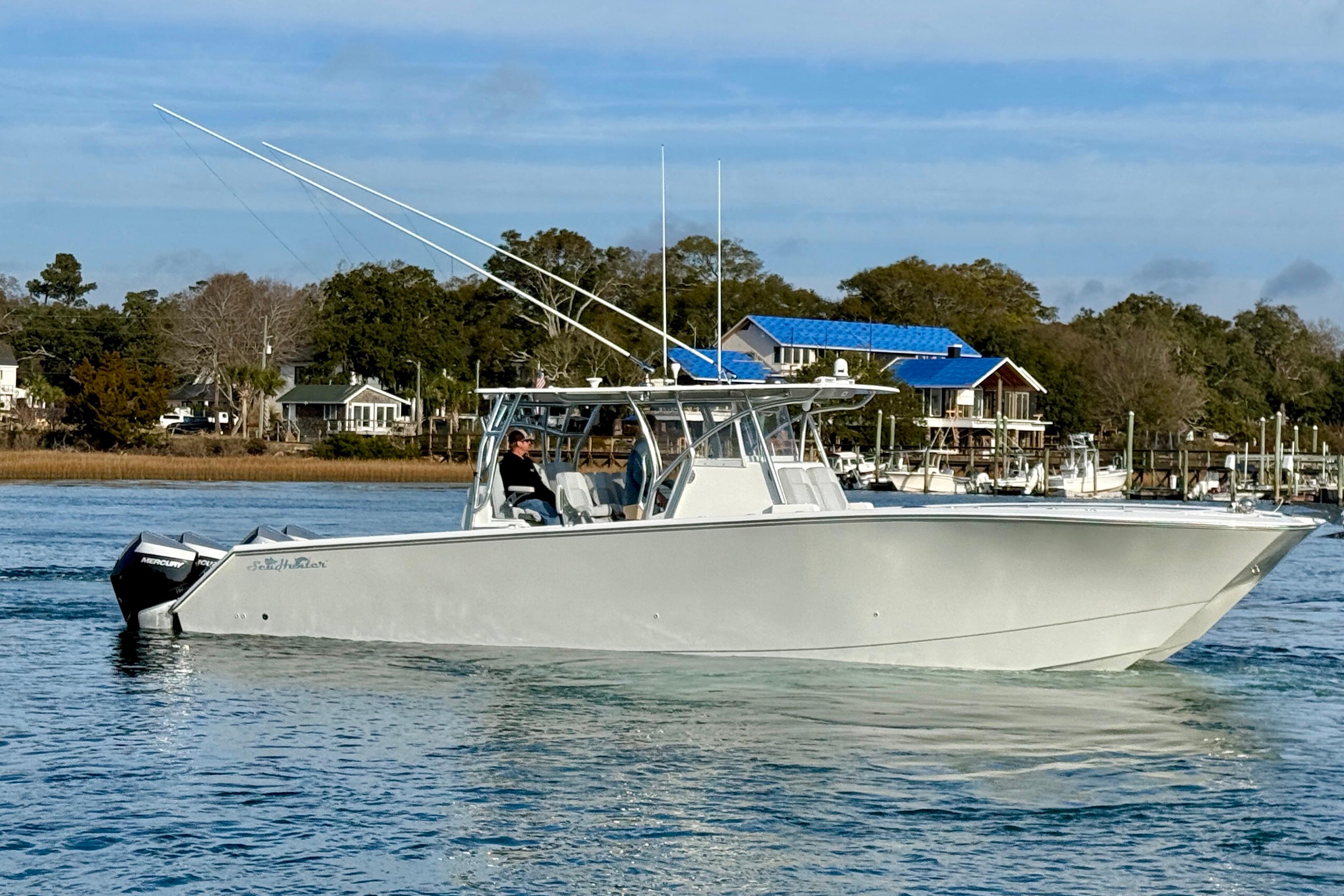 2021 SeaHunter 41 CTS boat cruising on a calm waterway with scenic background.