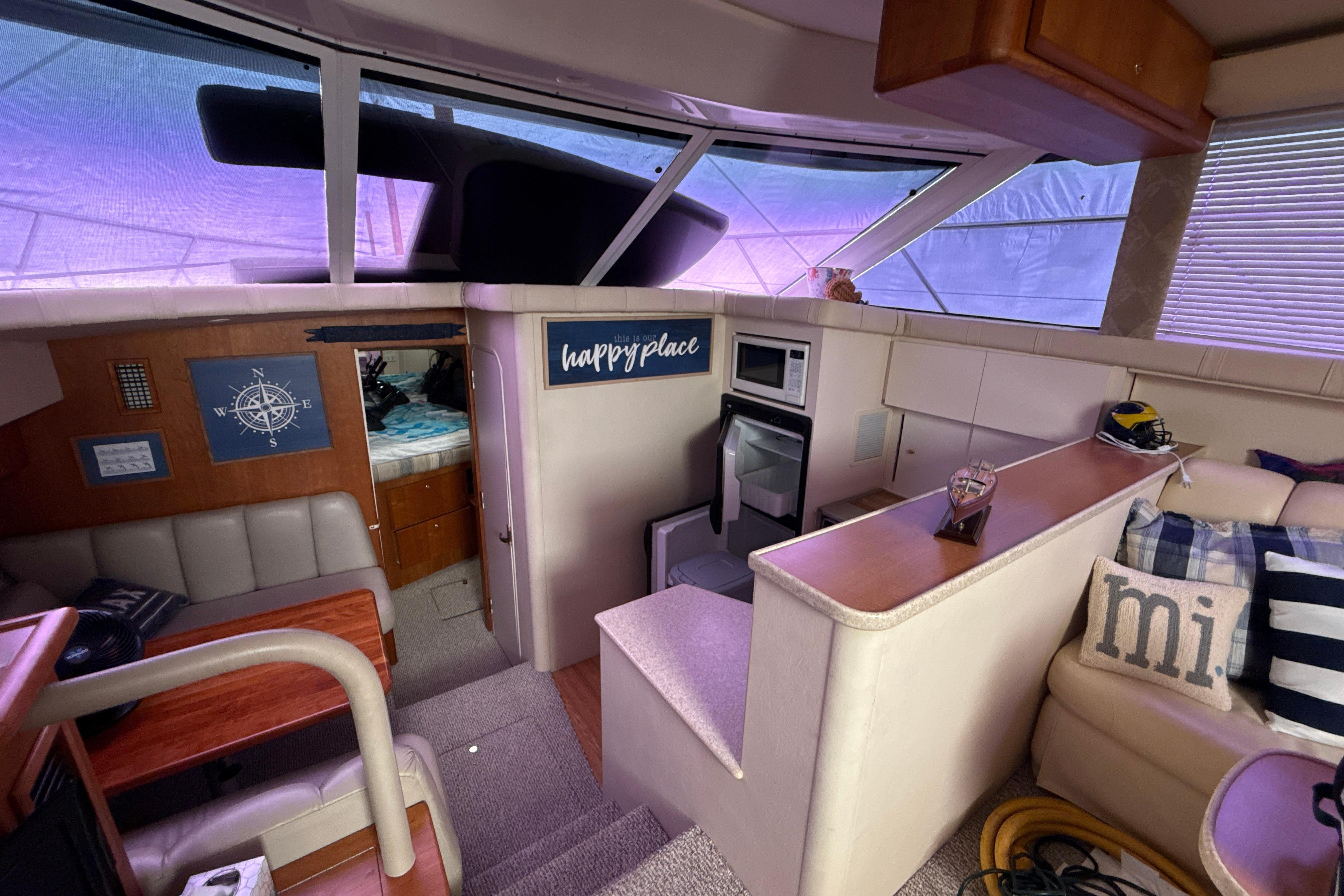 Interior of a 1999 Silverton 422 Motor Yacht with cozy seating and nautical decor.