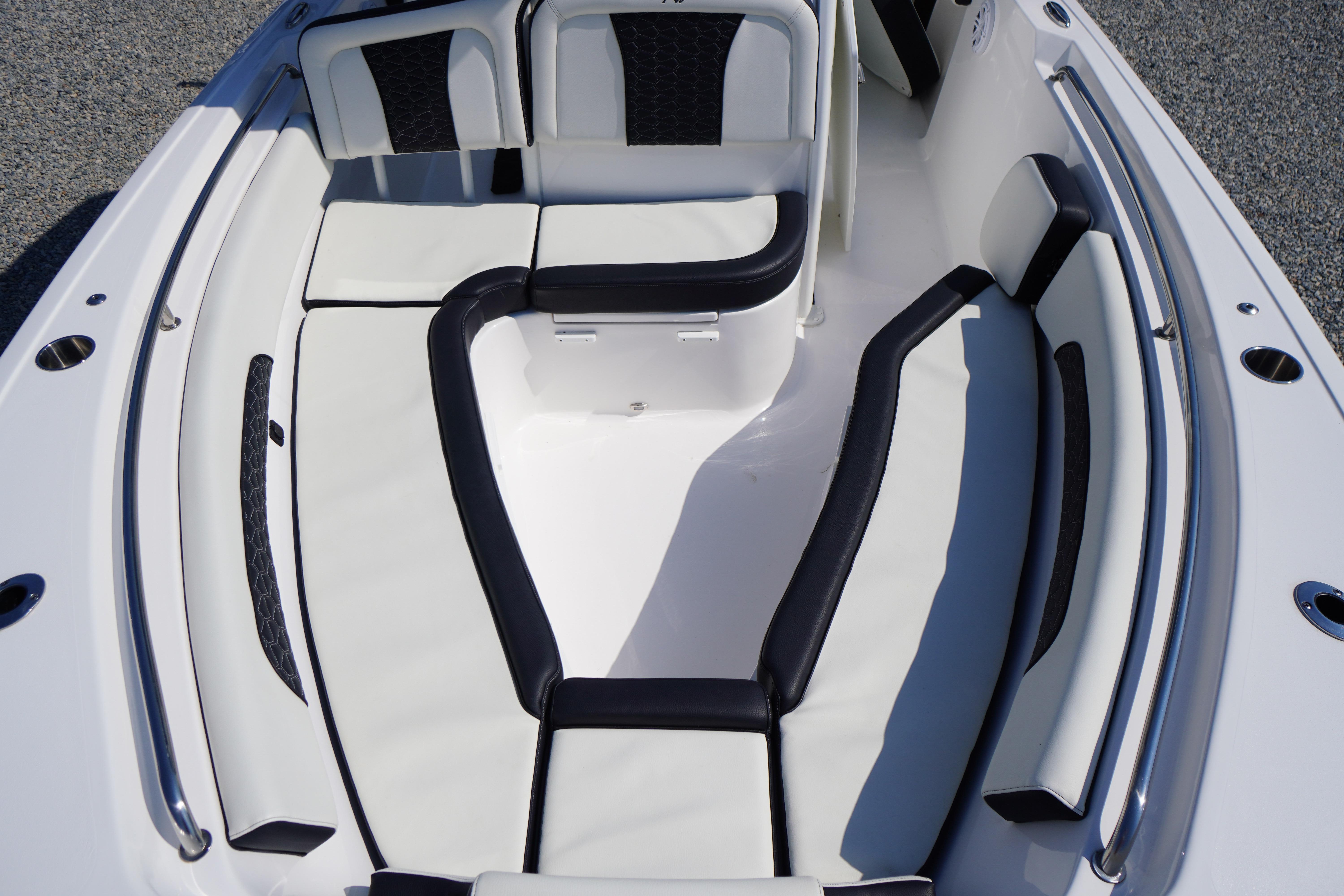 2025 Tidewater 232 SS boat interior with white and black cushioned seating.