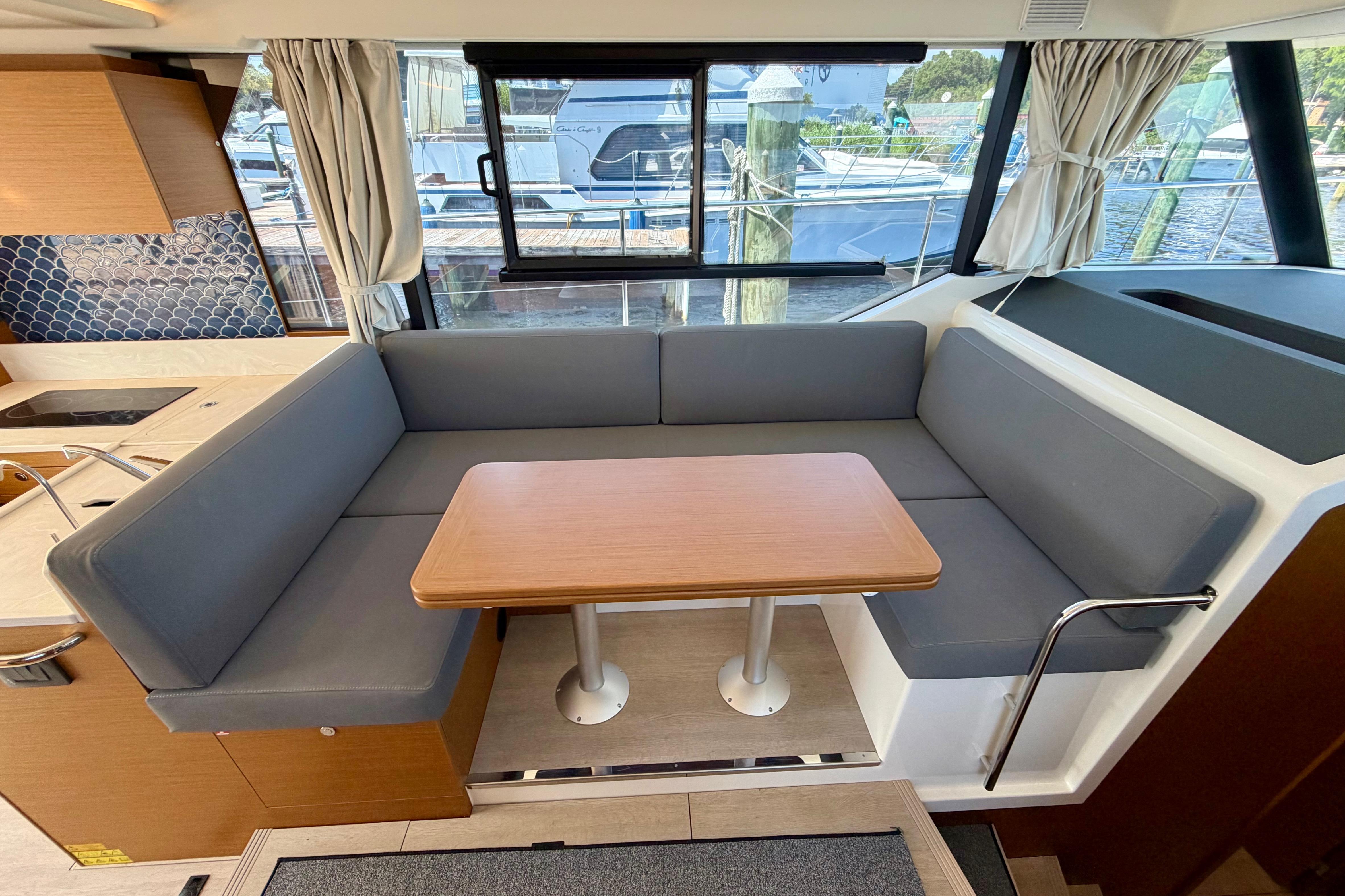Interior of 2025 Beneteau Swift Trawler 41 Fly with cozy seating and table.