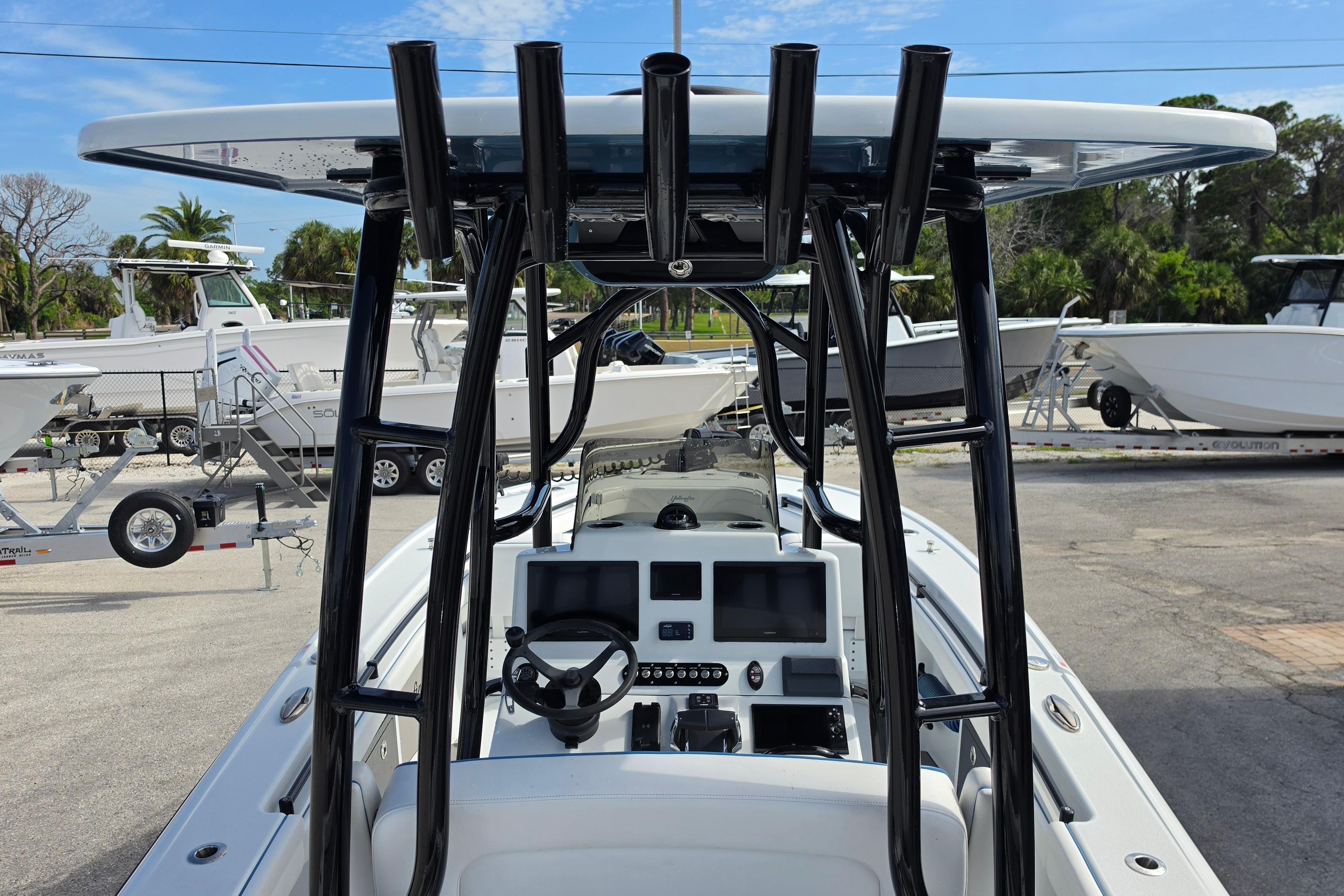 2025 Yellowfin 26 Hybrid boat dashboard with steering wheel and electronic displays.
