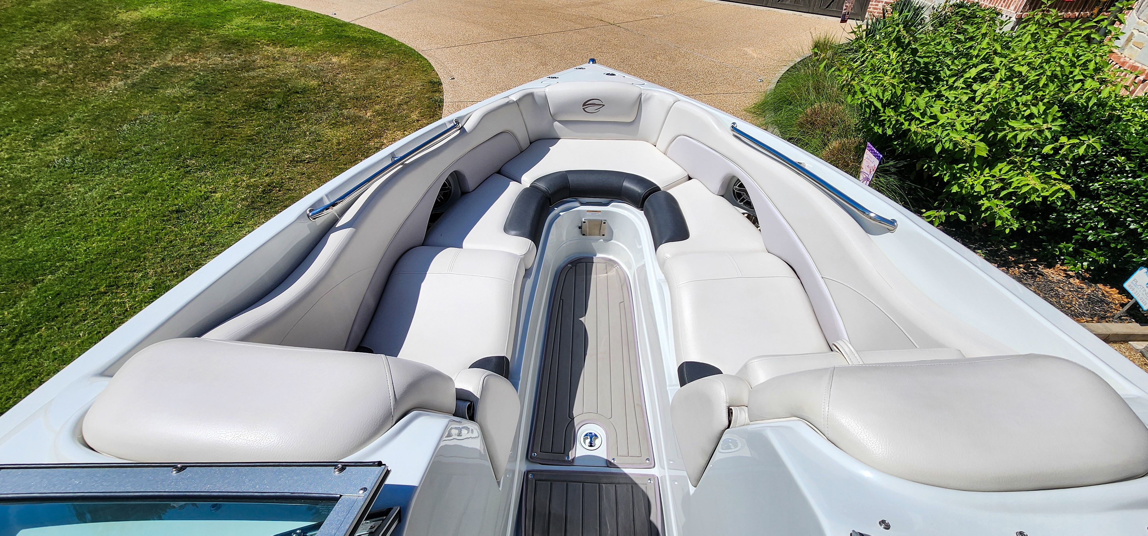 The image shows the cockpit of a 2017 Crownline 285SS boat with white upholstery.