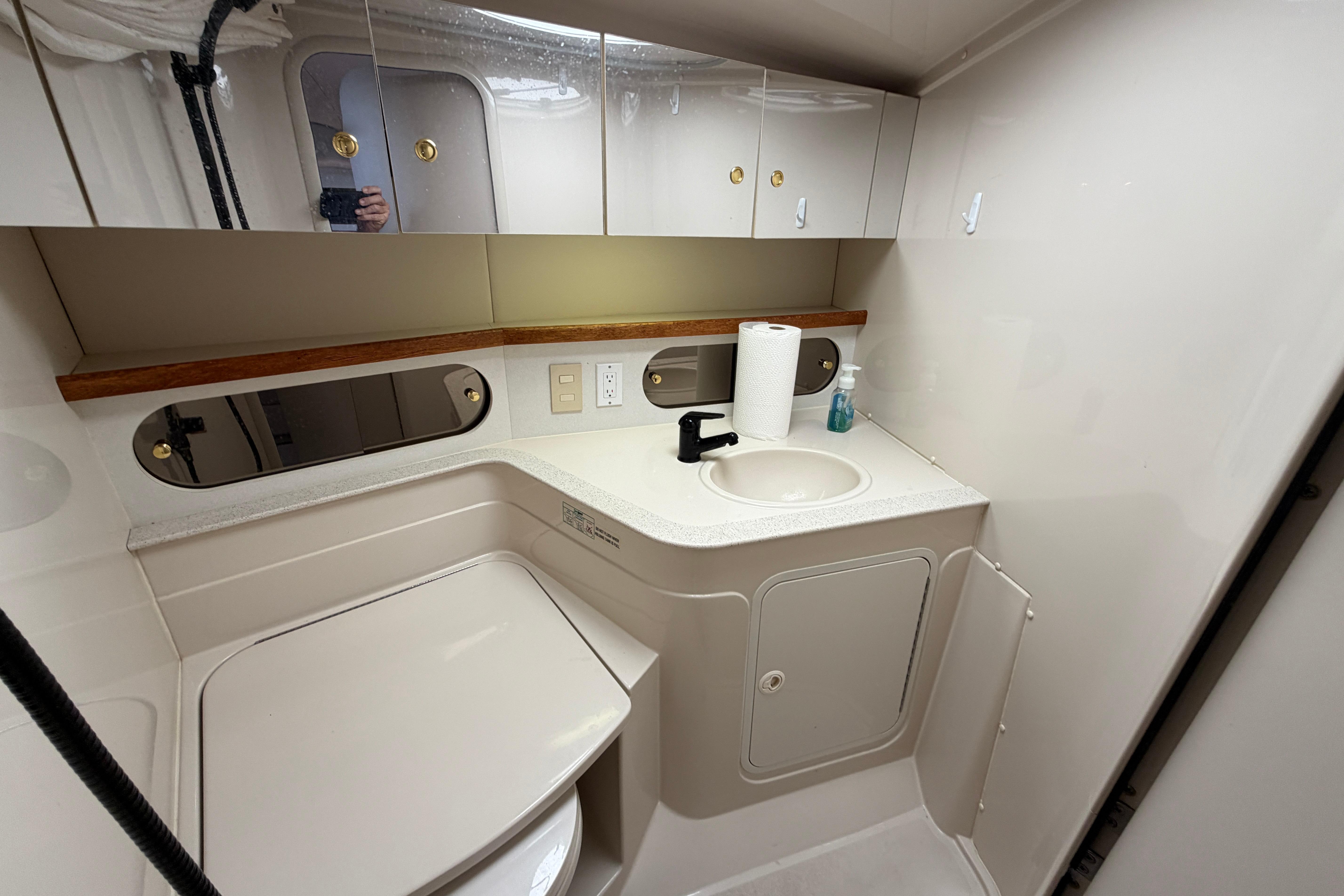 Bathroom interior of a 1997 Cruisers 3575 yacht, featuring sink and storage cabinets.