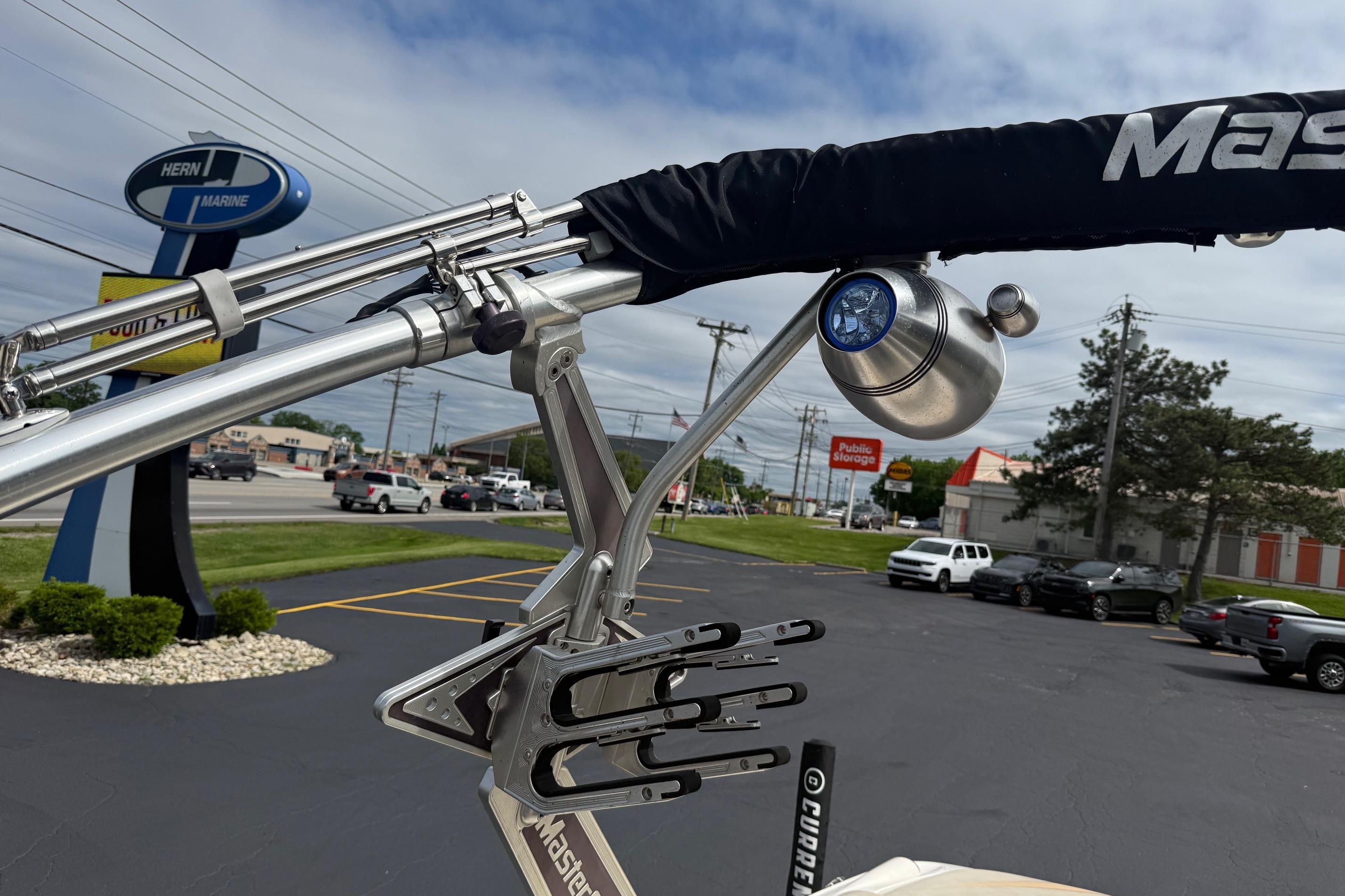 2008 MasterCraft X-15 boat tower with spotlight in a parking lot.