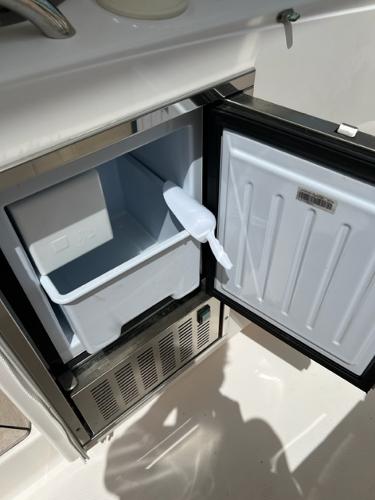2019 Pursuit S 408 Sport boat refrigerator with open door and ice tray.