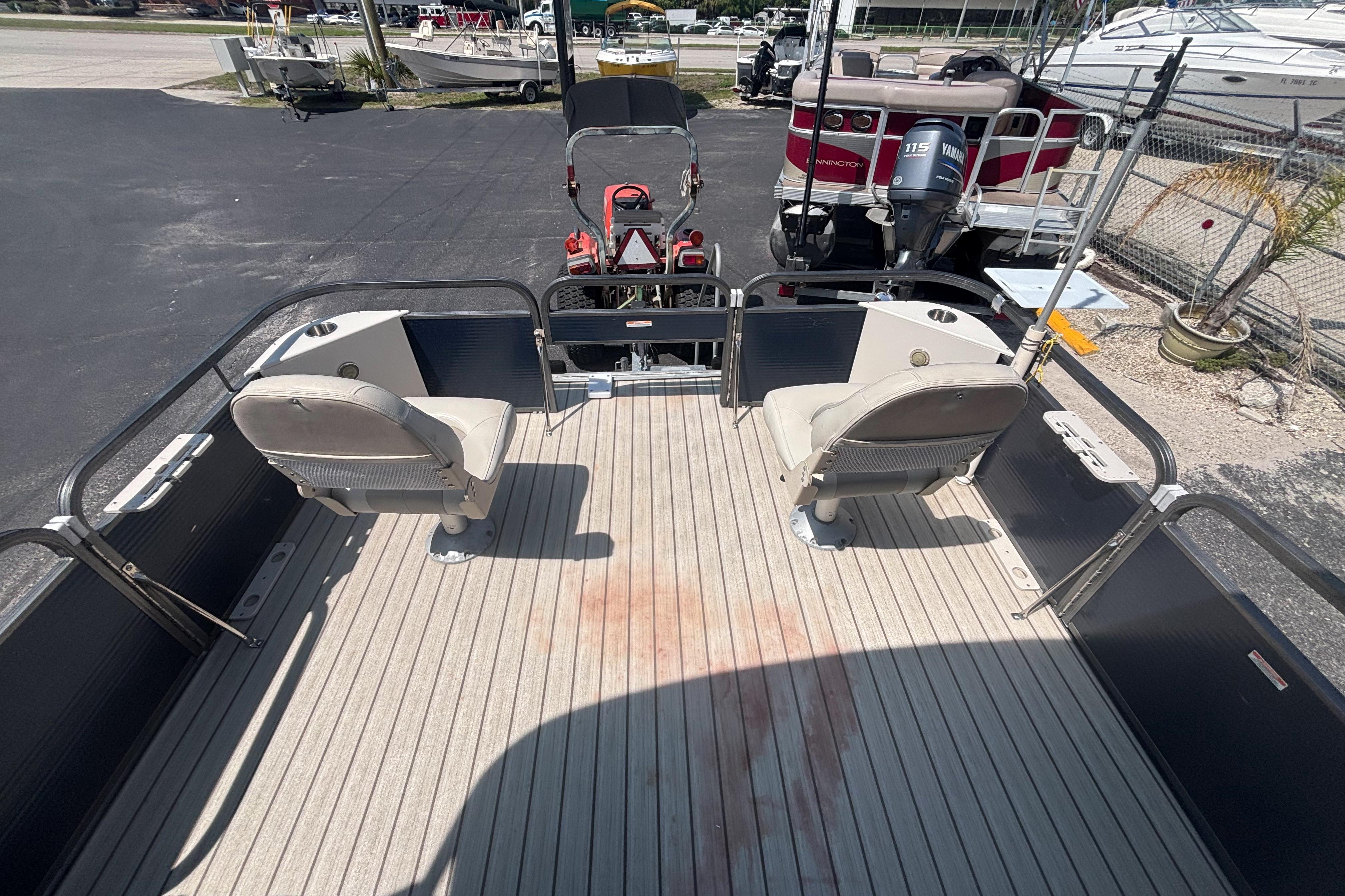 2015 Manitou 20 Oasis Angler pontoon boat with seating and fishing setup.