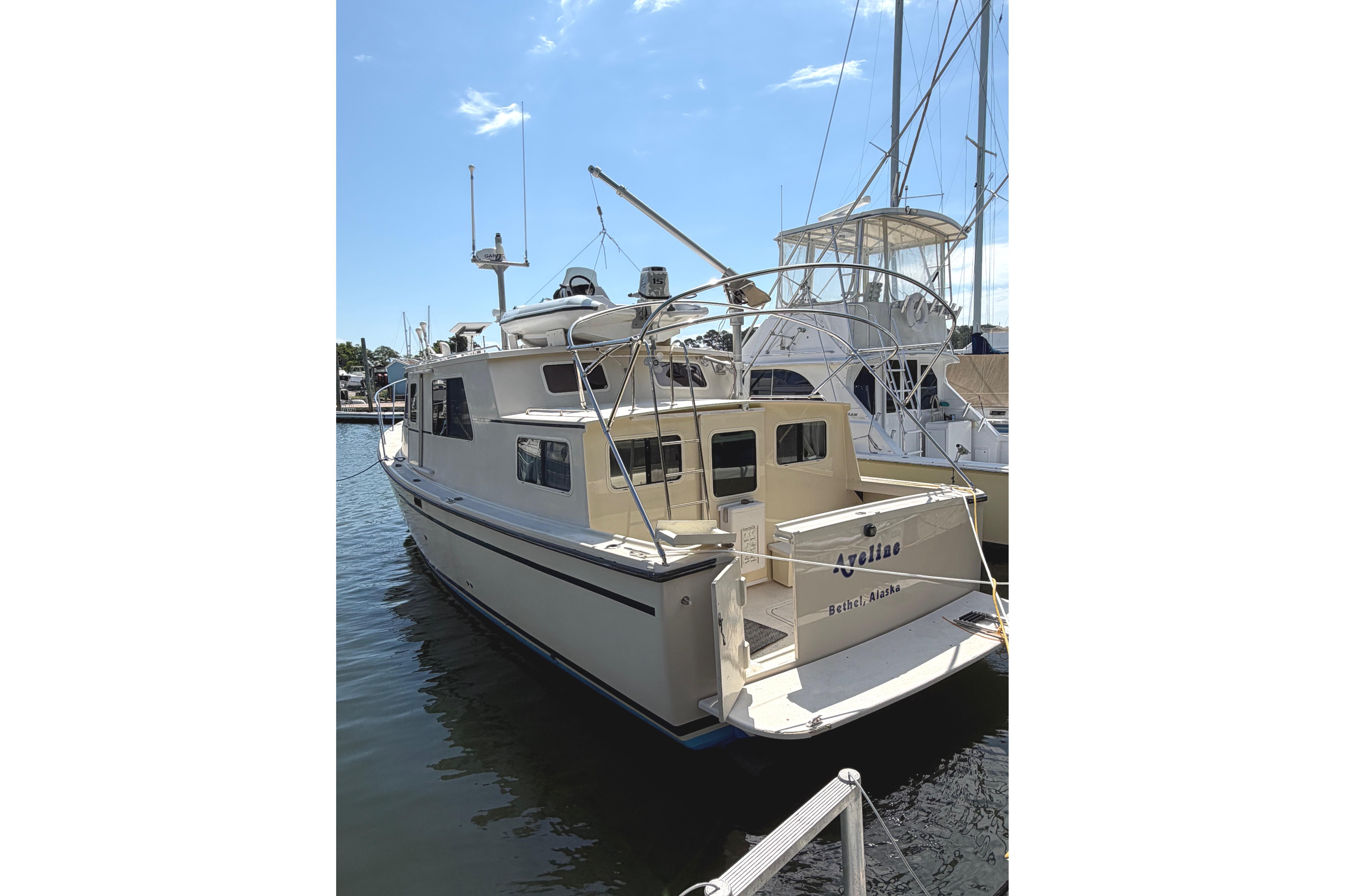 1997 Rosborough Trawler docked at marina under clear blue sky.
