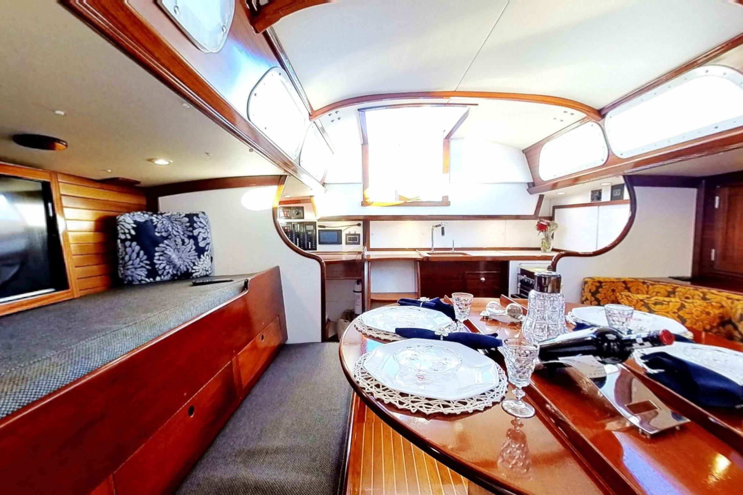 Interior of a 1970 Hinckley Bermuda 40 yacht with elegant dining setup.
