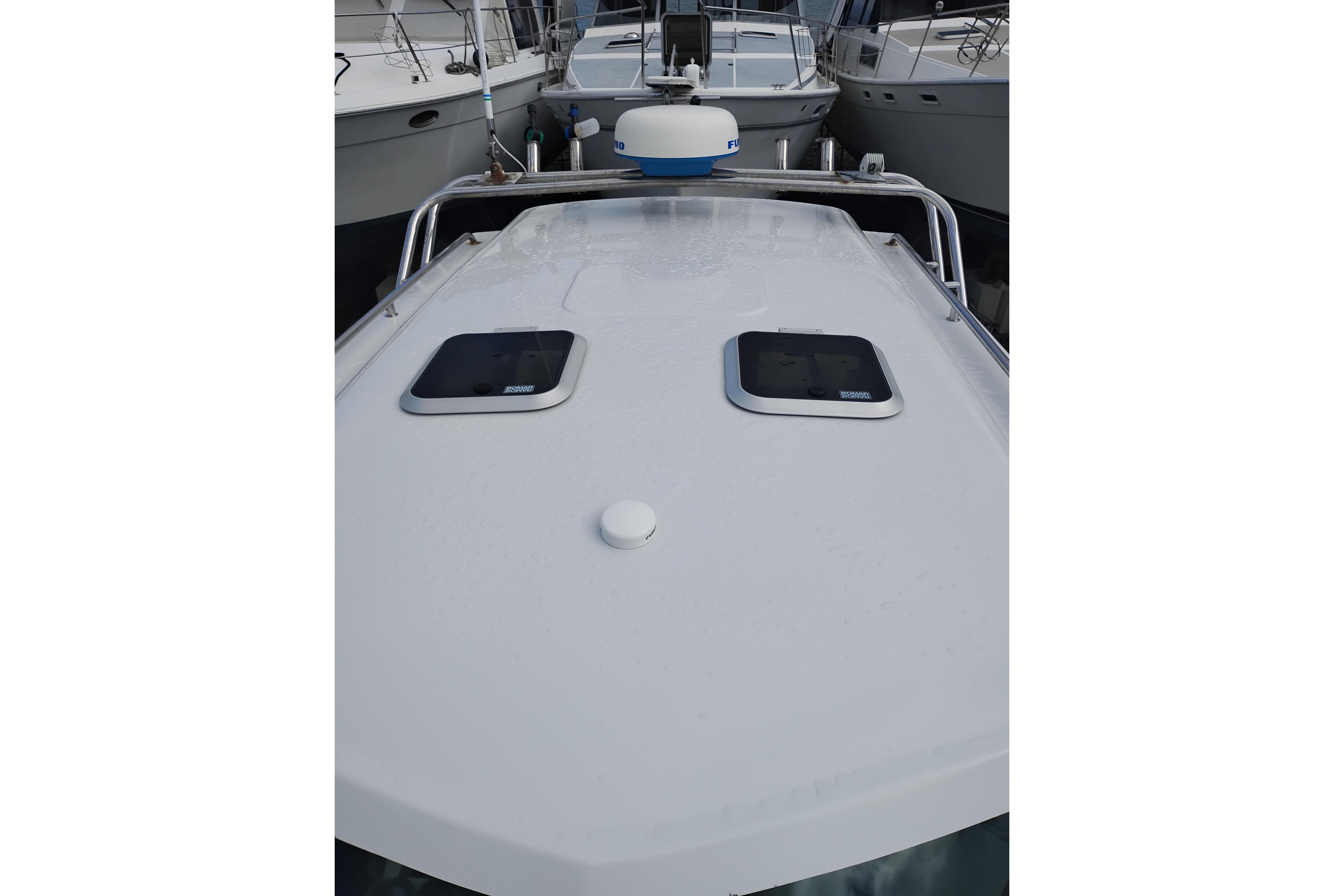2007 Glacier Bay 2685 Coastal Runner boat deck with hatches and radar.