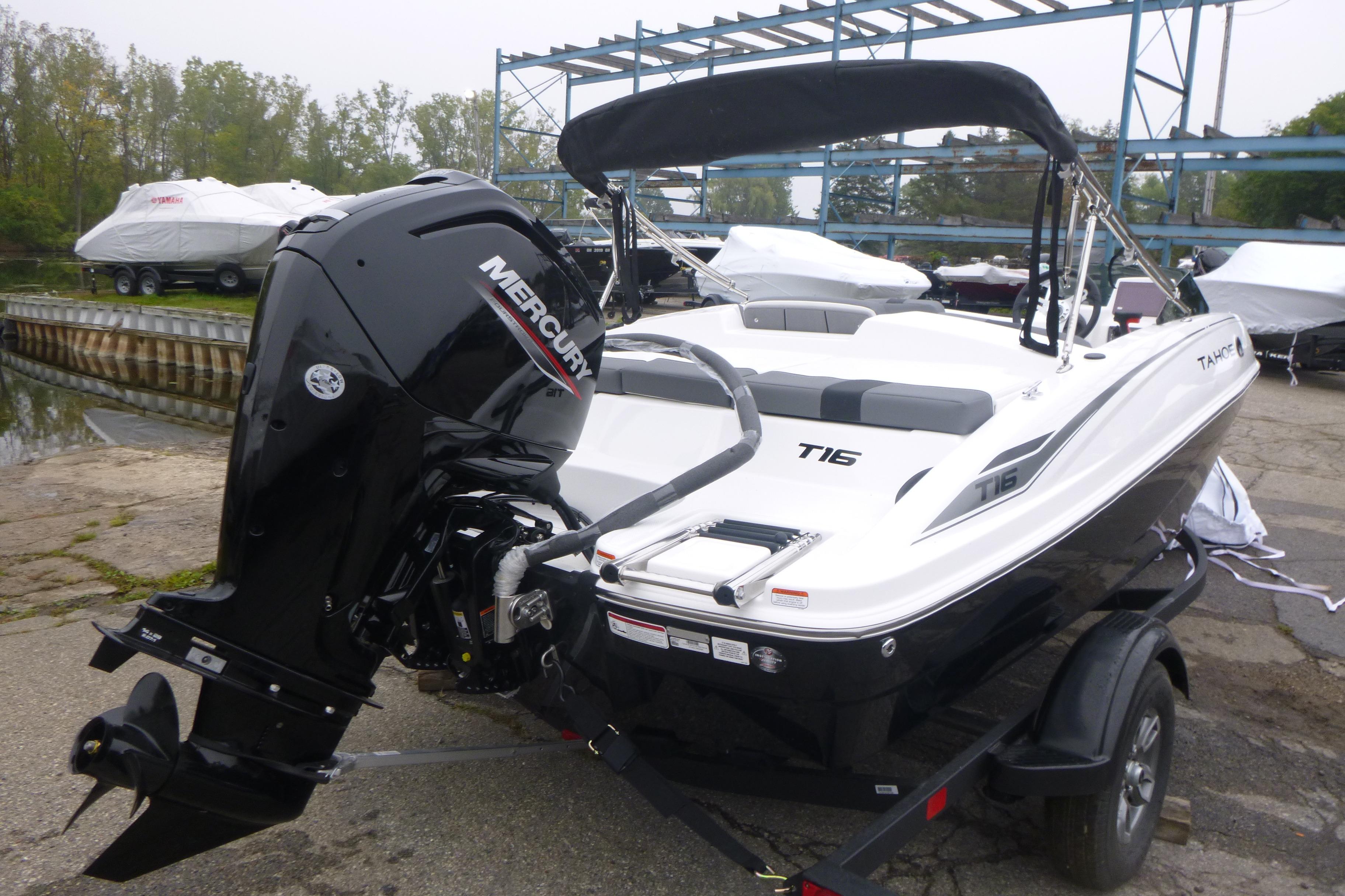 2026 Tahoe T16 boat with Mercury engine on trailer, dockside setting.