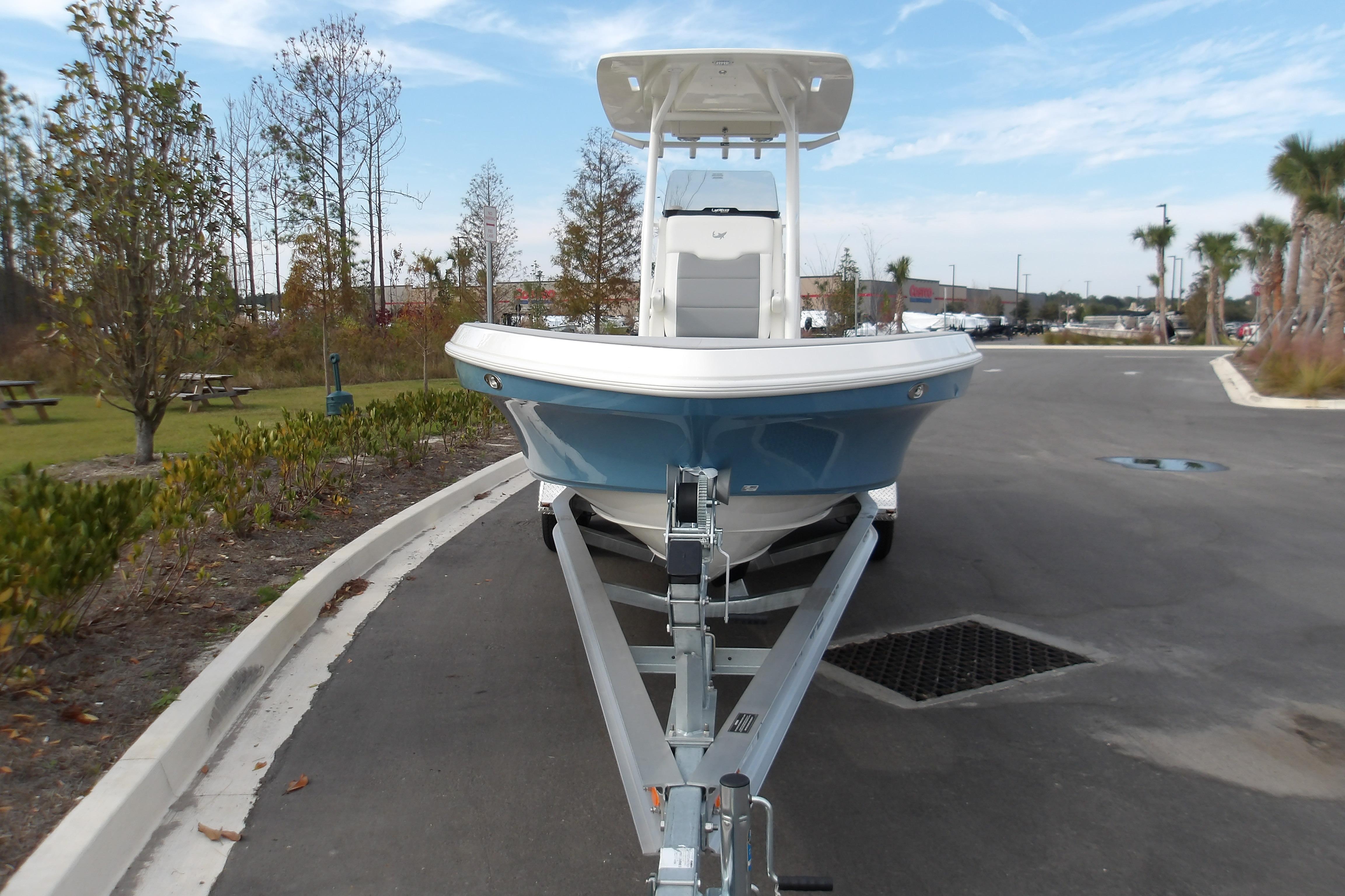 2026 Mako 24 APEX boat on trailer, parked in outdoor setting.