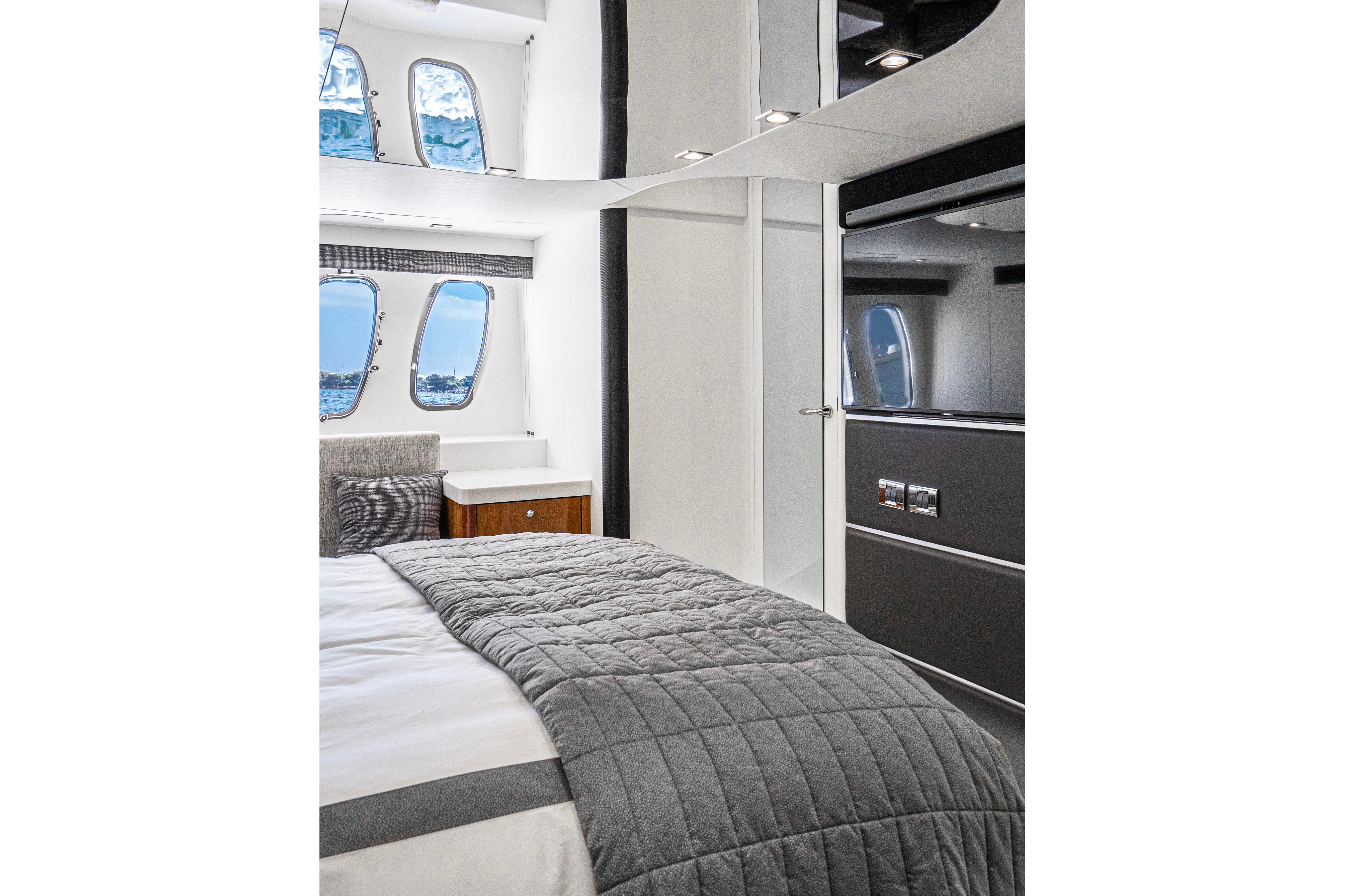 Luxurious interior of 2021 Sunseeker Predator 68 yacht bedroom with modern design.