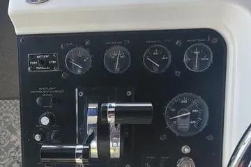 Control panel of a 1991 Carver 42 Aft Cabin Motor Yacht with gauges and levers.
