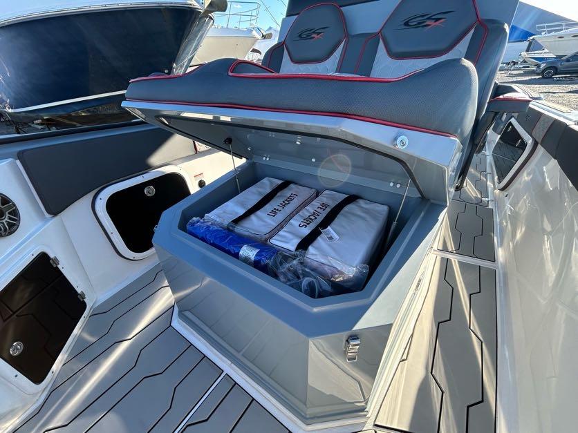2024 Glasstream 32 GSX boat with open storage compartment under seat.