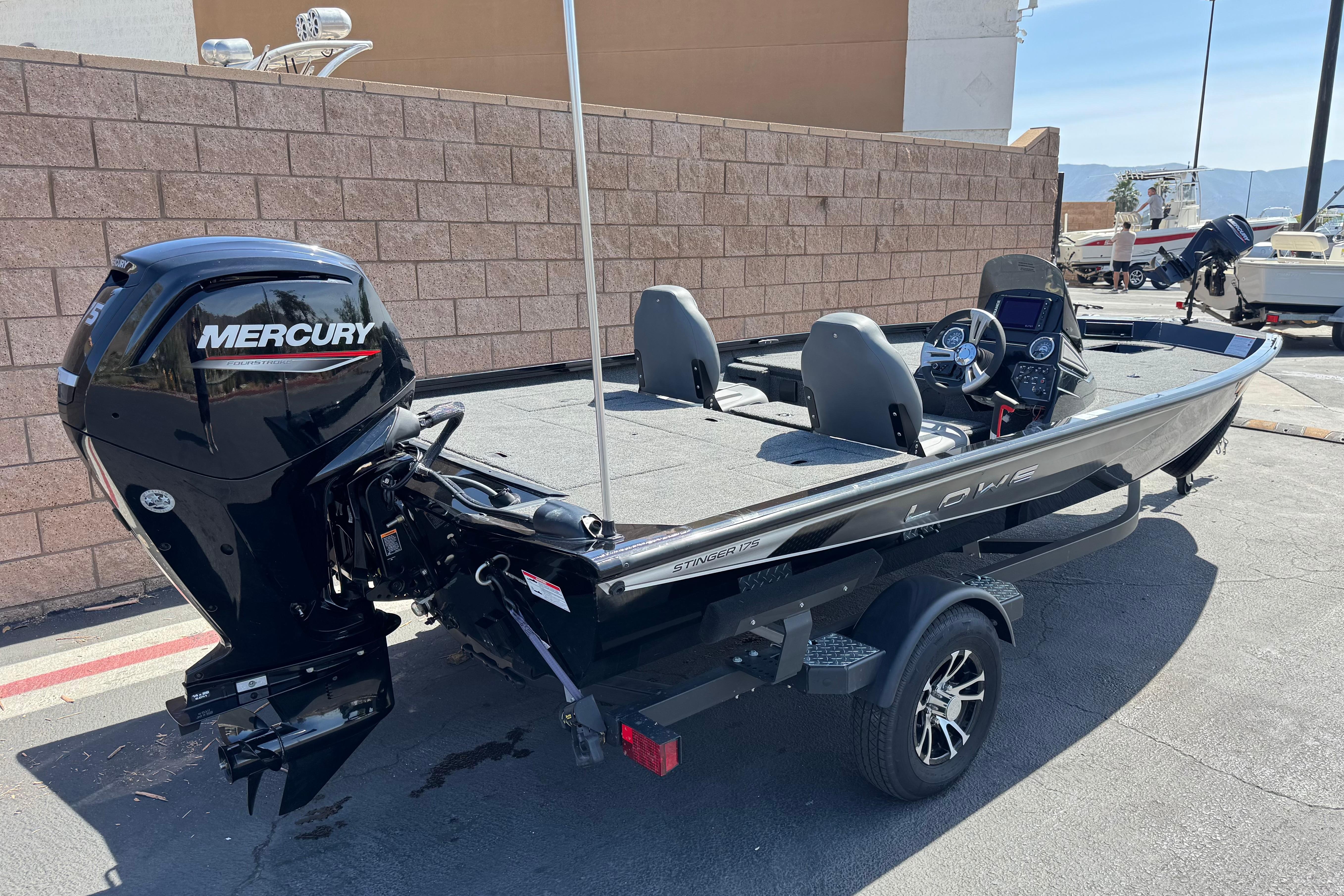 2024 Lowe Stinger 175 boat with Mercury outboard motor, parked on a trailer.