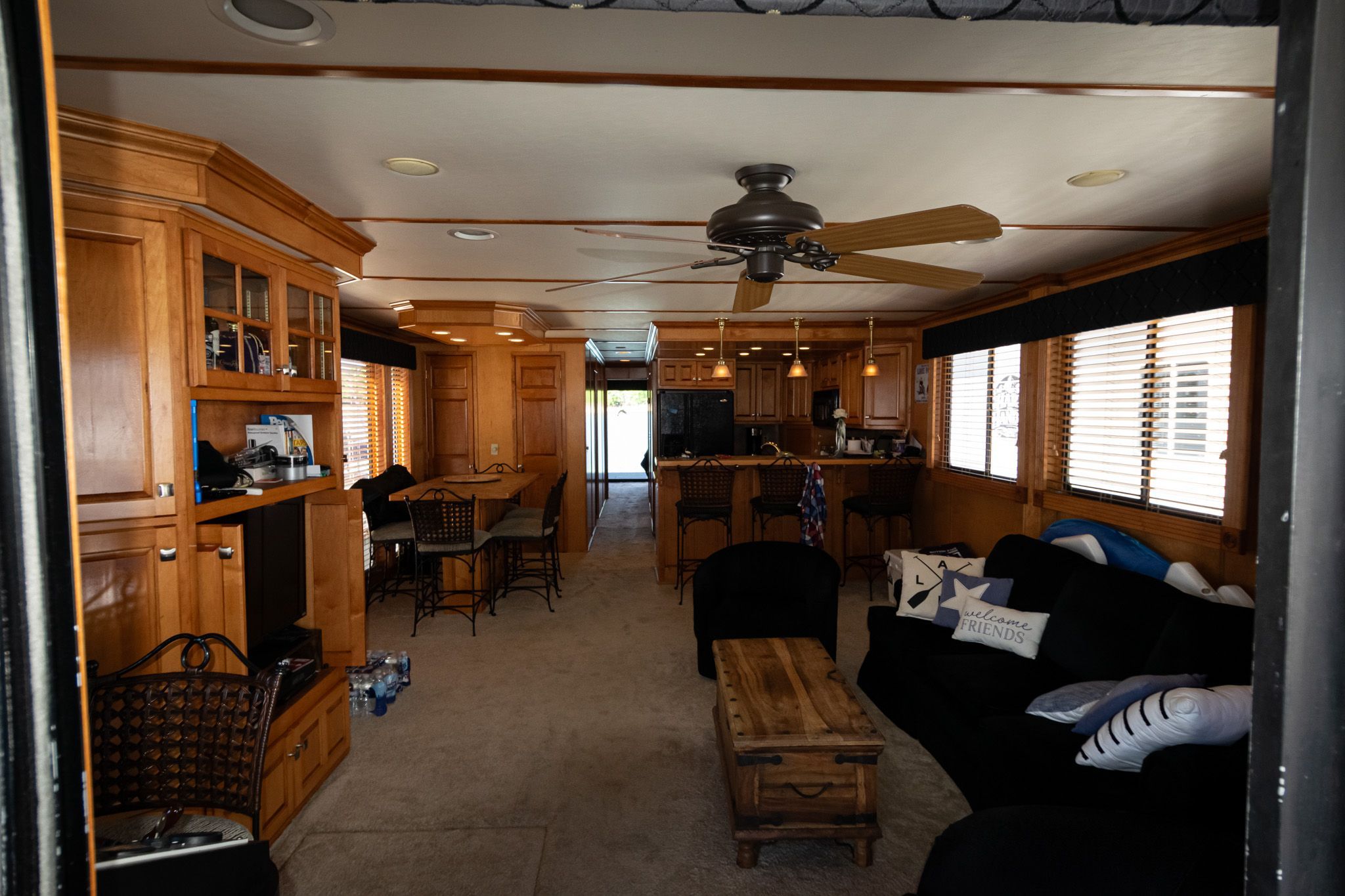 Interior of a 2003 Lakeview 16x70 houseboat with wooden furnishings.