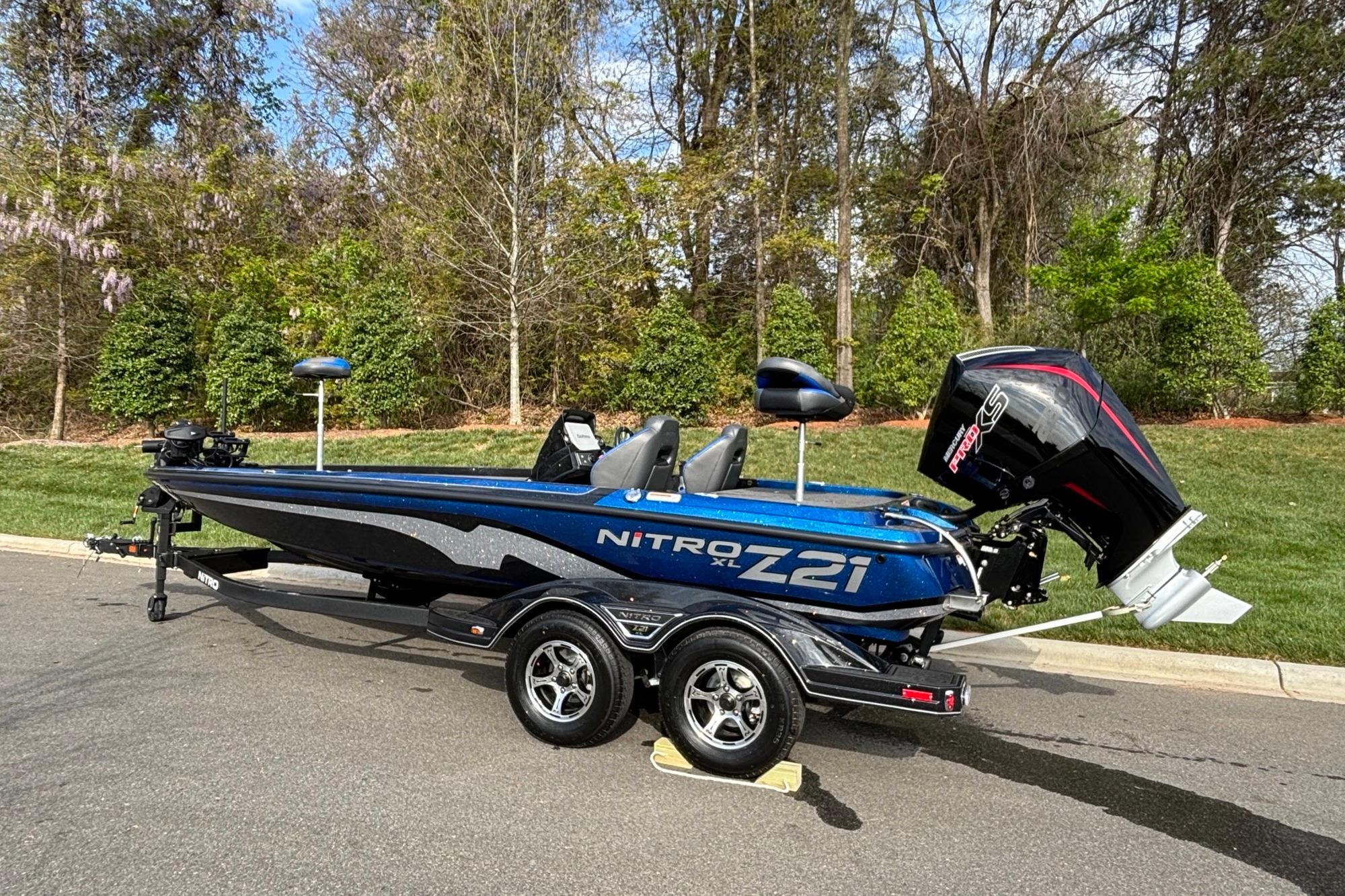 2026 Nitro Z21 XL Pro boat on trailer, parked outdoors with trees in background.