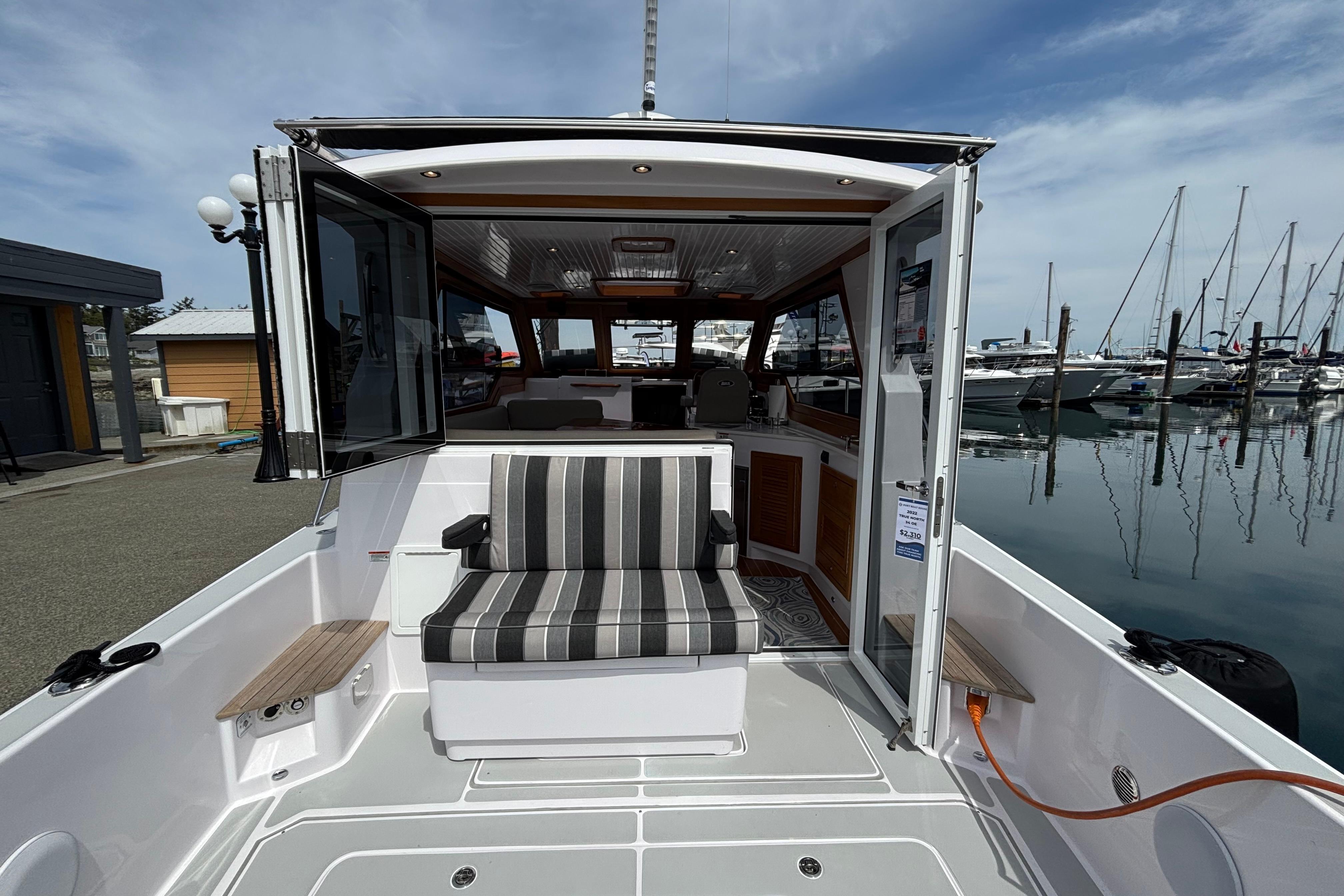 True North 34 OE 2022 yacht at dock with open cabin.