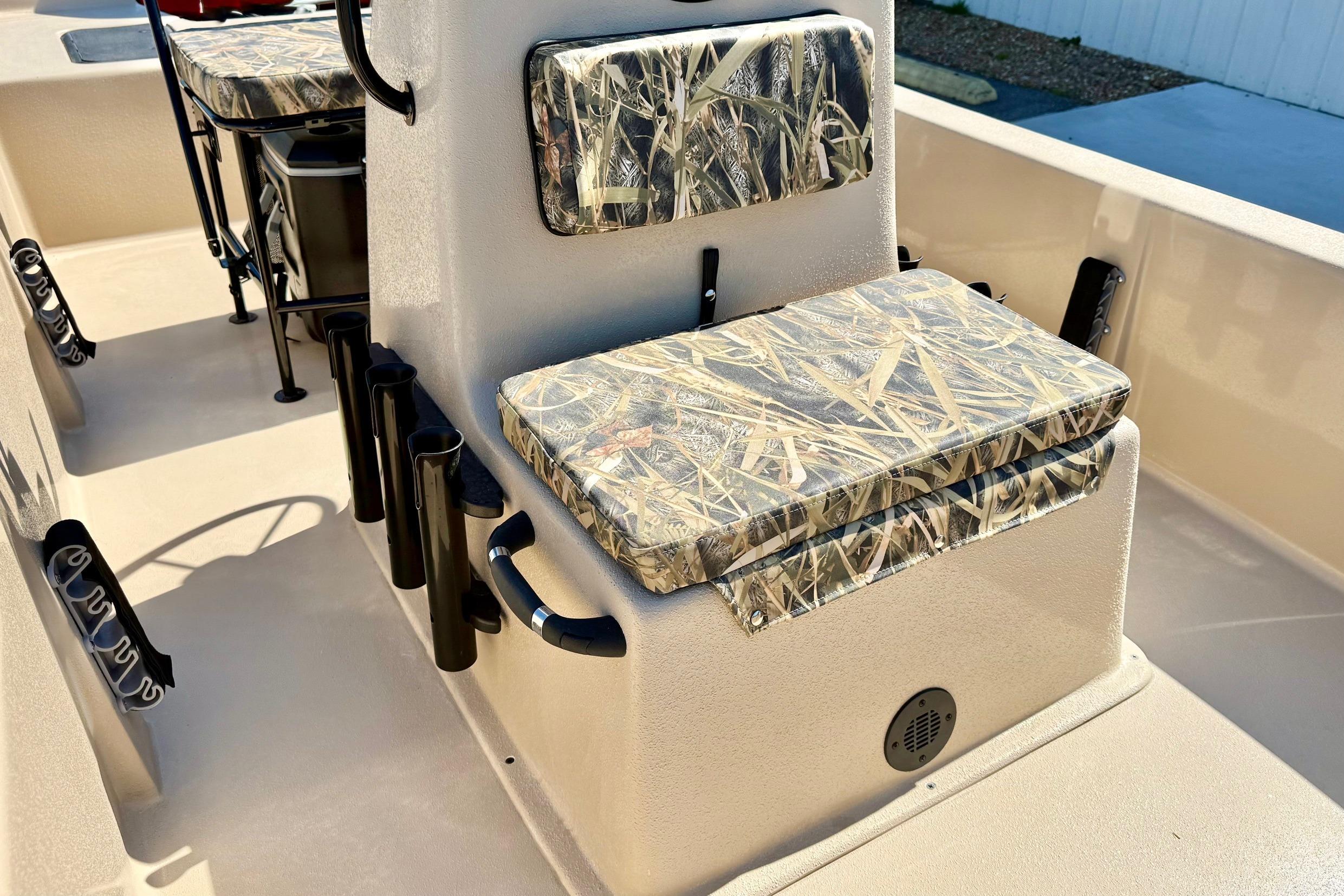 2026 Carolina Skiff E18 JVX CC boat interior with camo-patterned seating and rod holders.