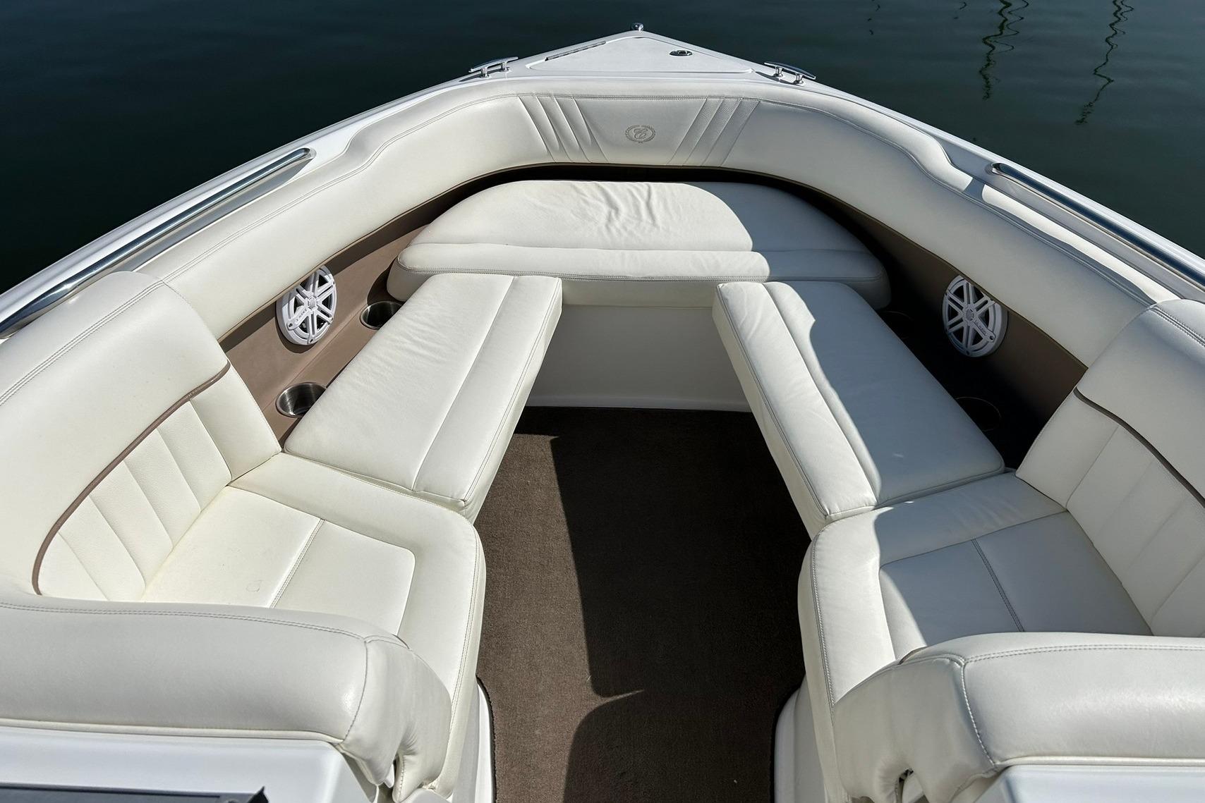 Interior of a 2007 Cobalt 232 boat with white leather seating.