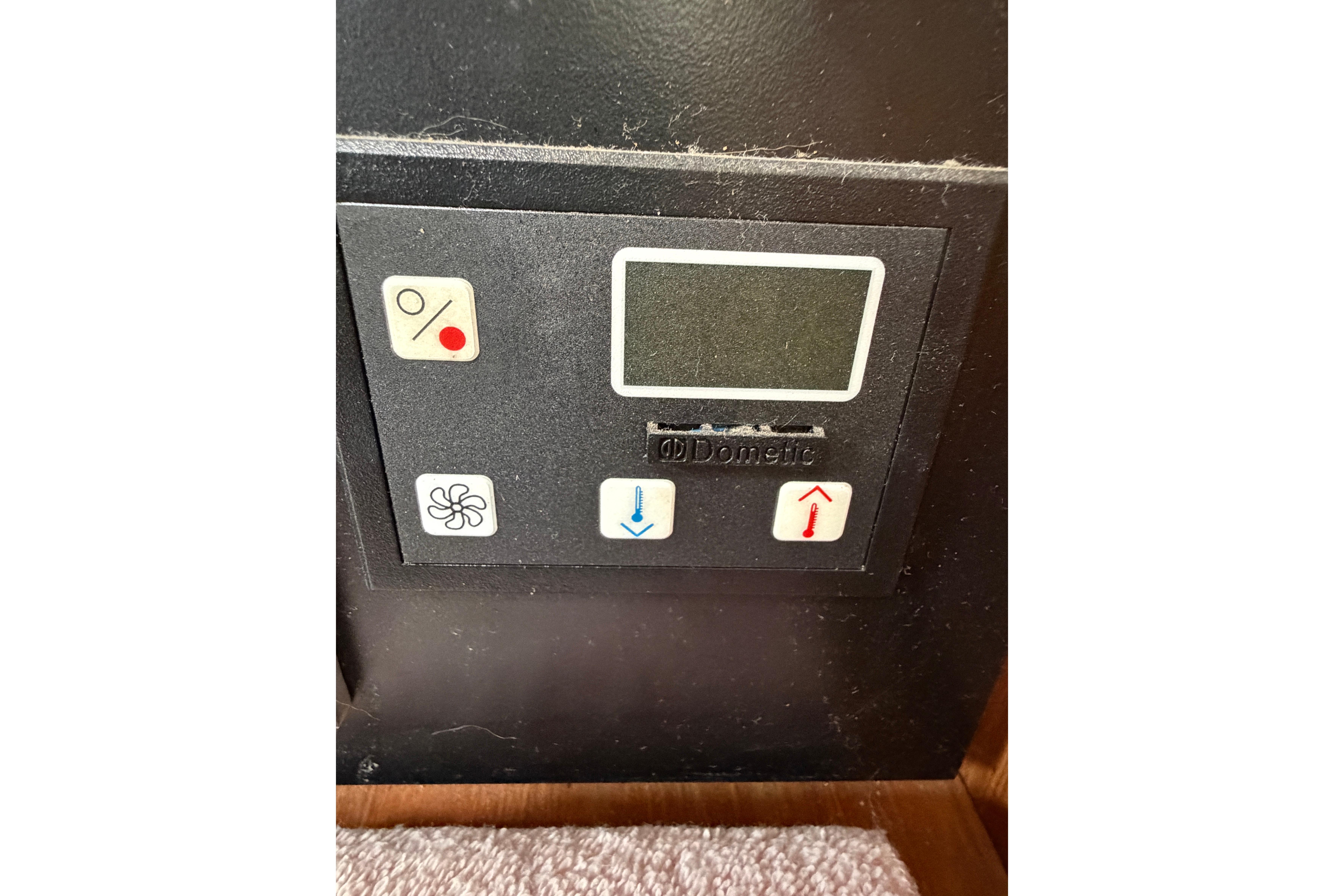 Control panel of a 2002 Catalina 470 boat, featuring Dometic display and buttons.