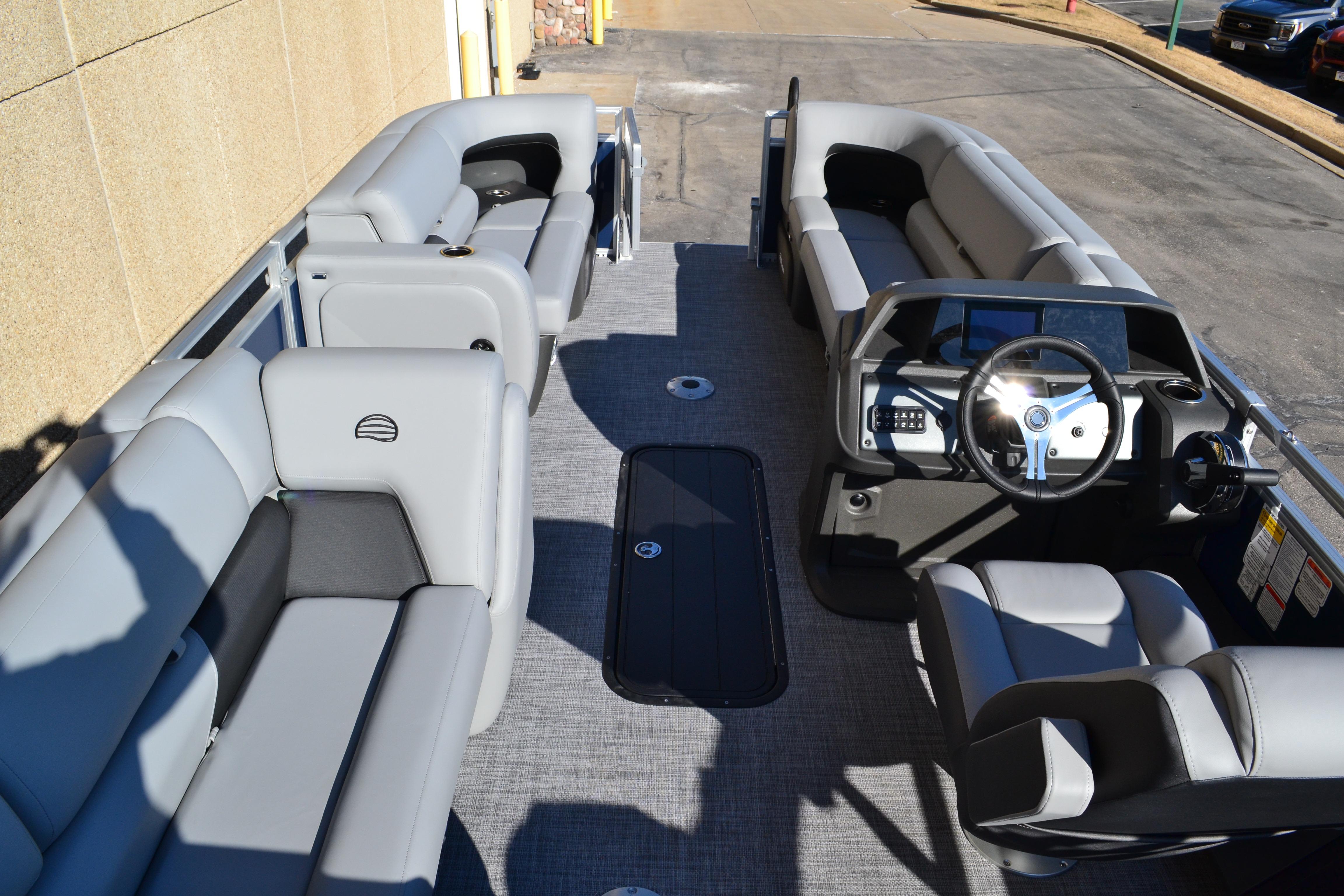 2026 Sun Tracker SportFish 22 XP3 pontoon boat interior with gray seating and steering console.