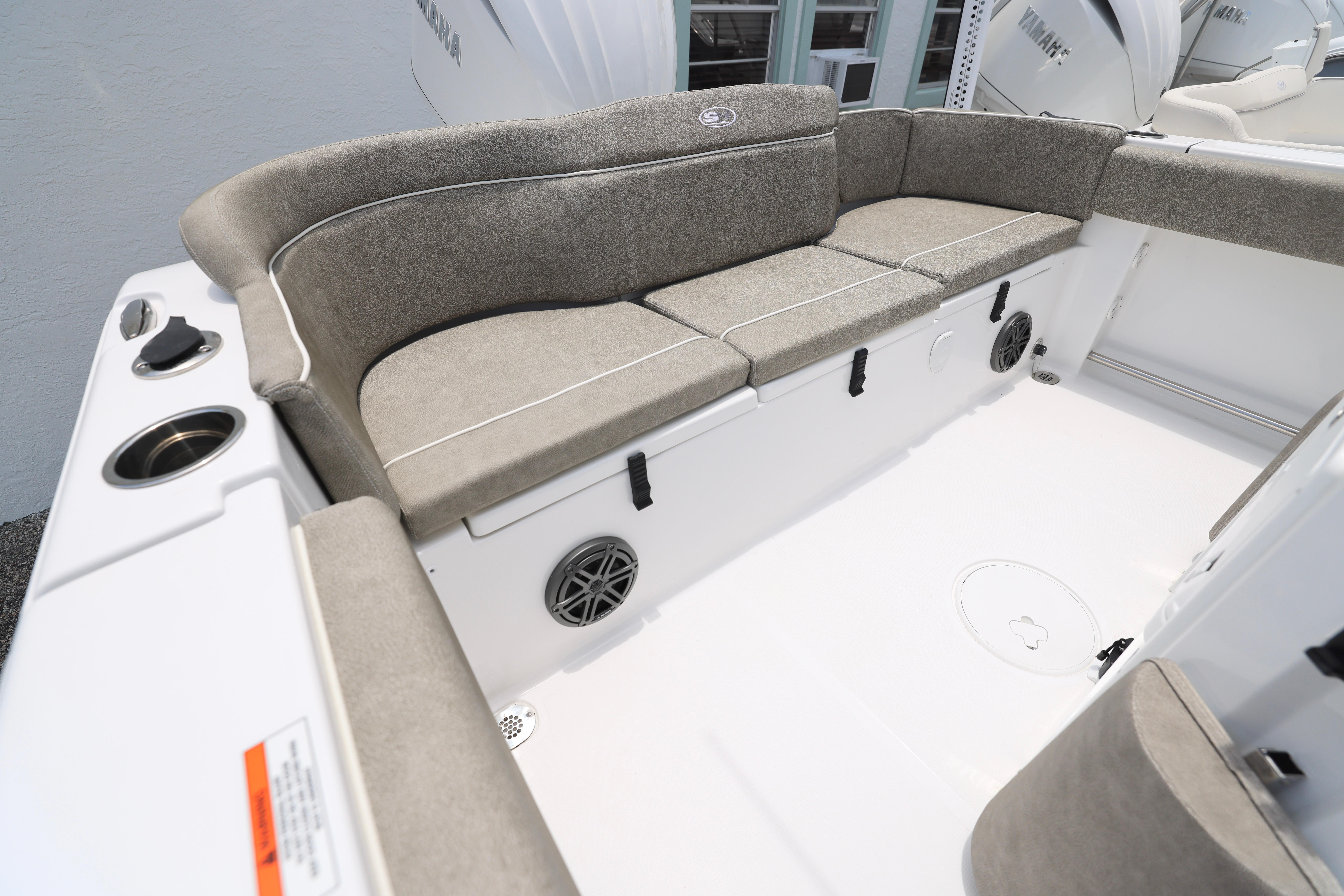 2026 Sea Hunt Ultra 245 SE boat interior with cushioned seating and cup holders.