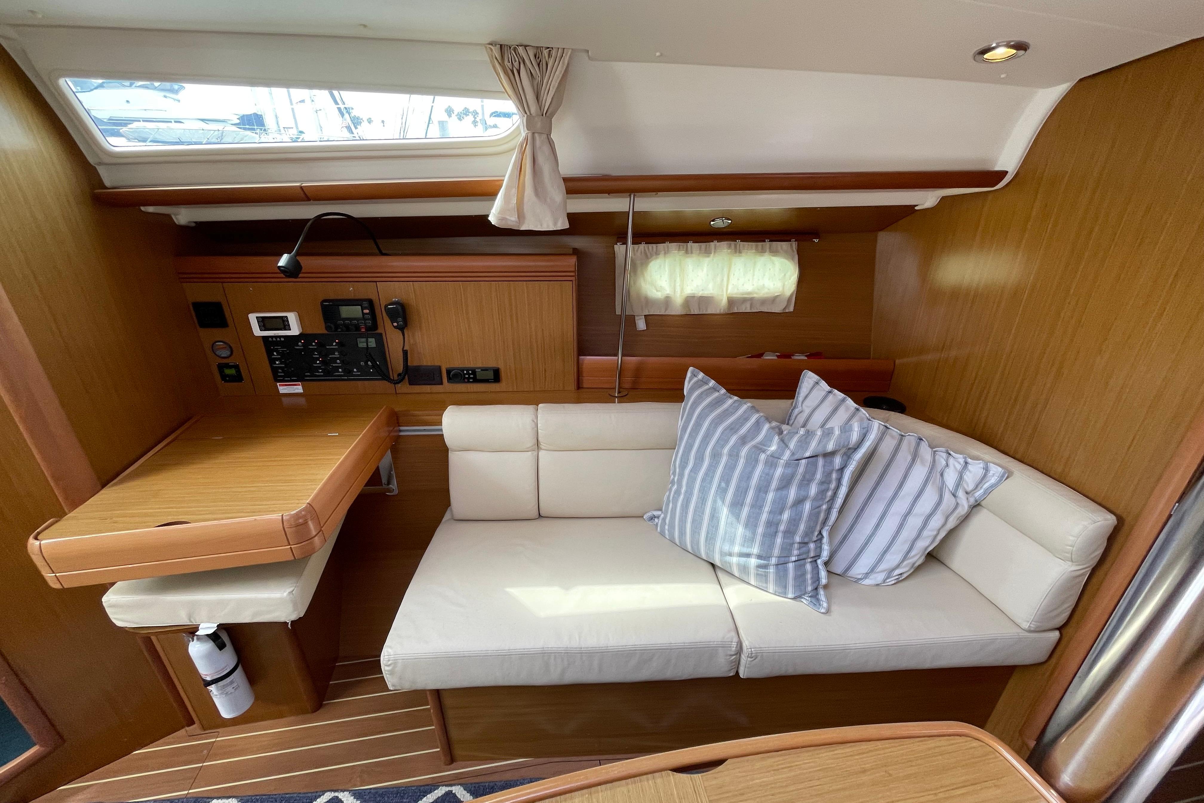 Interior of 2007 Jeanneau Sun Odyssey 39 DS with cozy seating and navigation station.