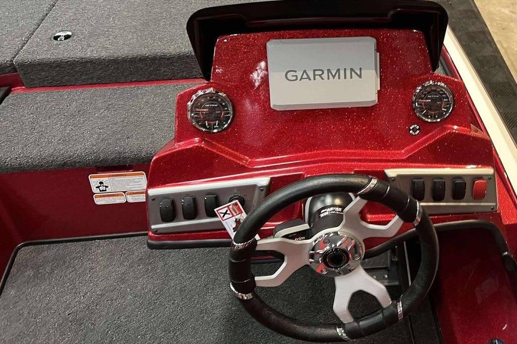 Red Nitro Z18 Pro 2026 boat dashboard with Garmin display and steering wheel.