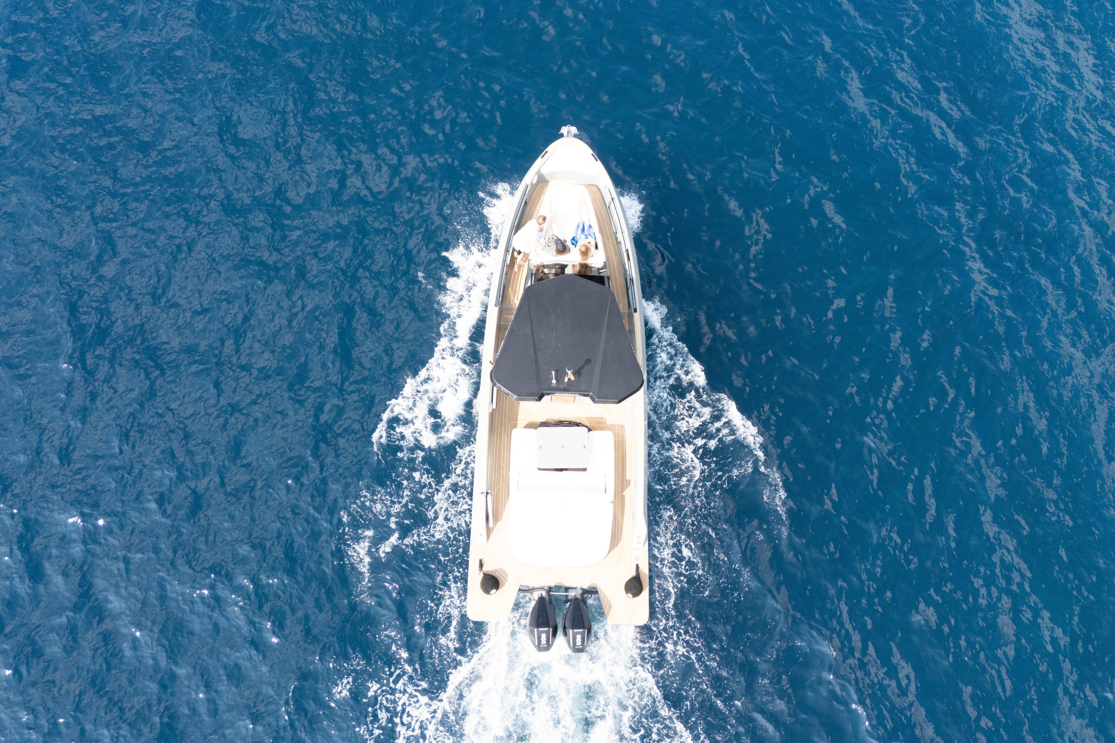 Aerial view of 2025 Kumbra 34 boat cruising on blue ocean waters.