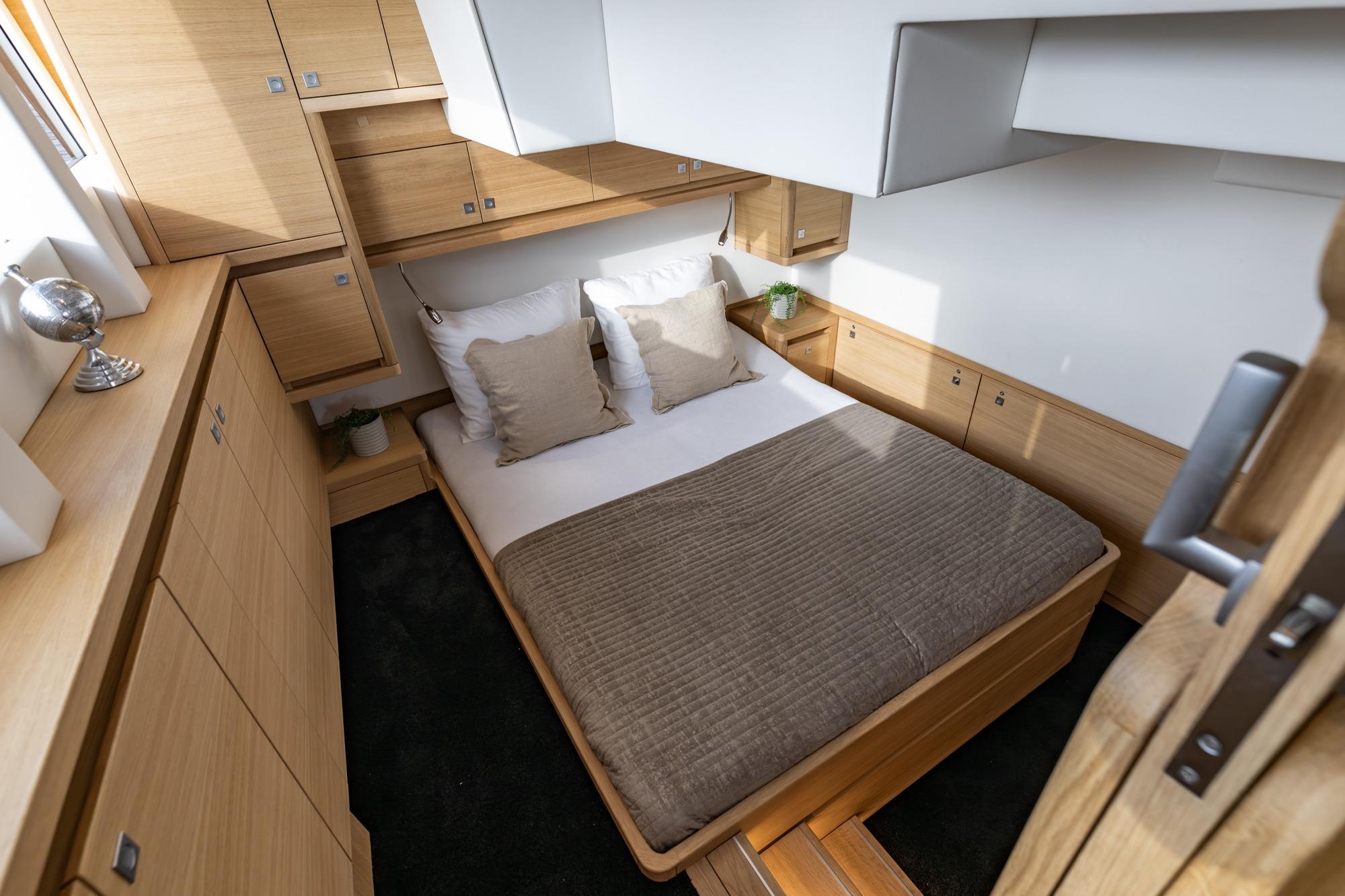 Luxurious bedroom interior in 2017 Steeler Panorama FF 53 yacht, featuring wooden cabinetry.
