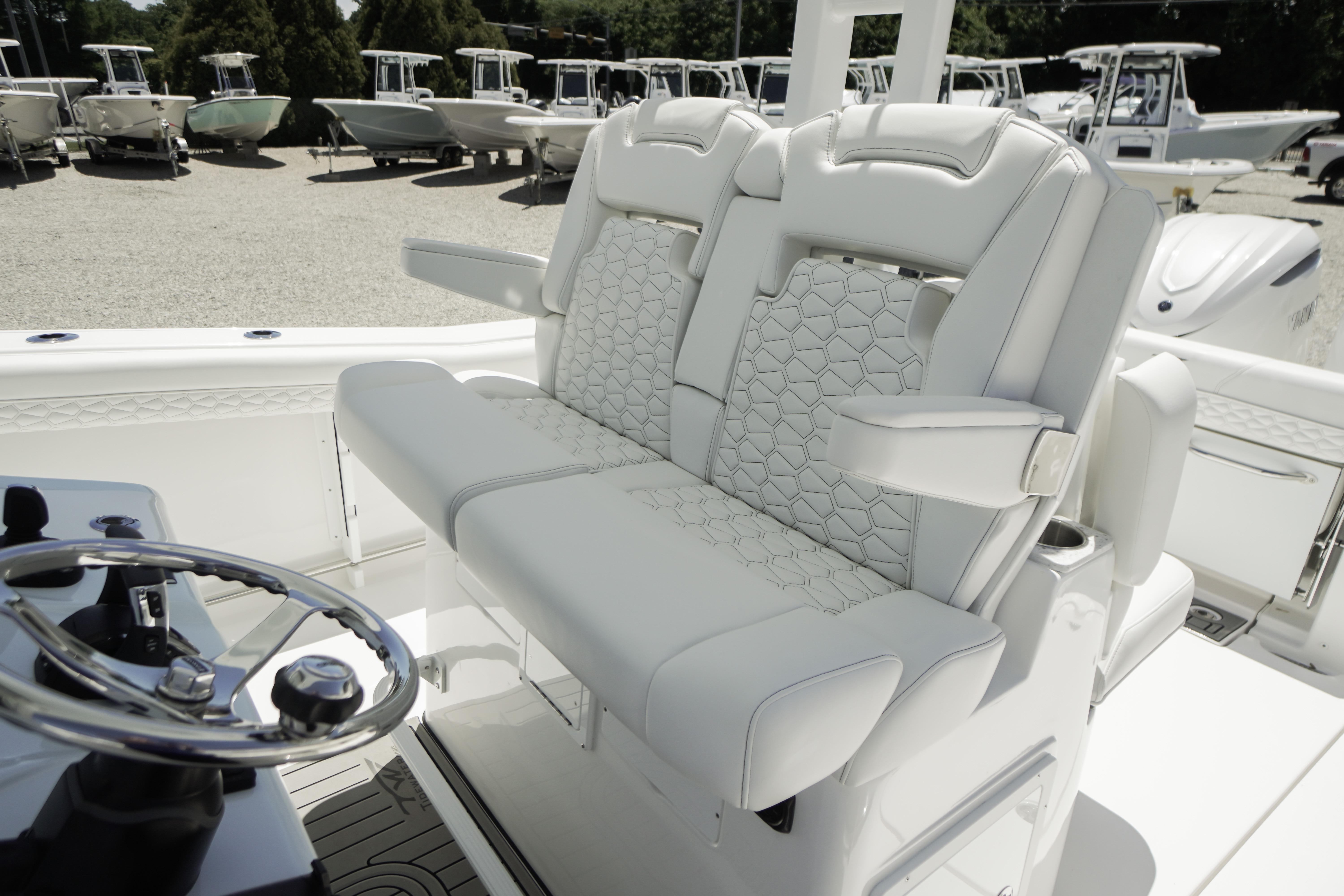 Luxury seating on 2026 Tidewater 302 CC Adventure boat, featuring elegant white upholstery.