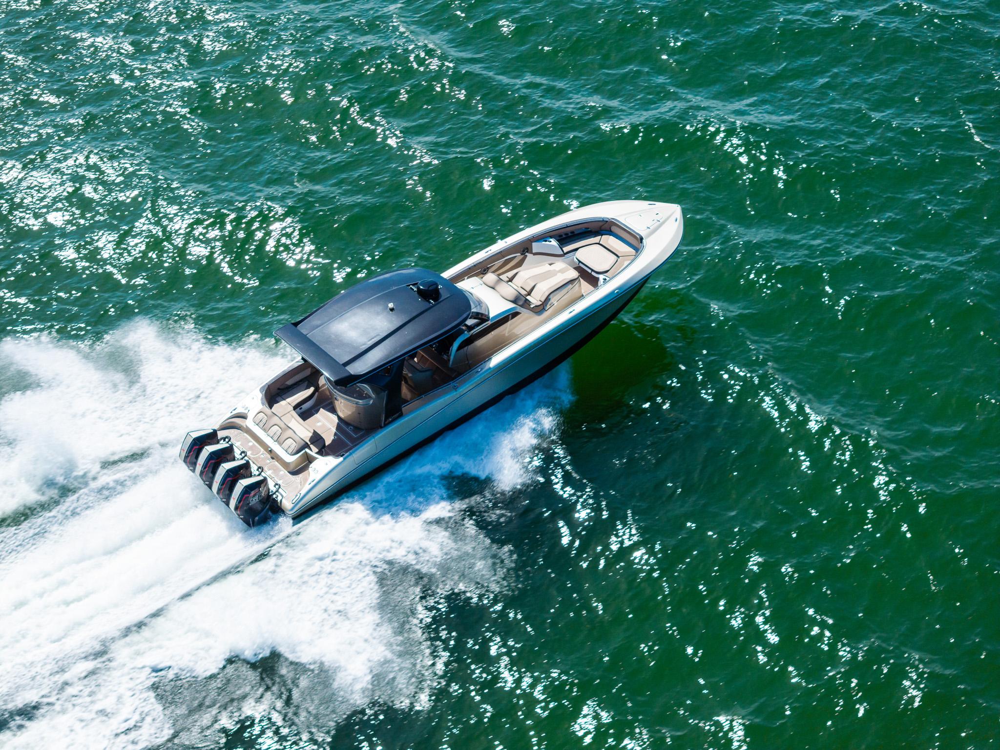 MTI V42 2021 speedboat cruising on open water, aerial view.