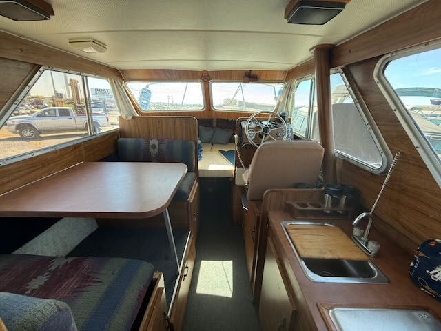 Interior of a 1979 Tollycraft 26 yacht with wooden furnishings.