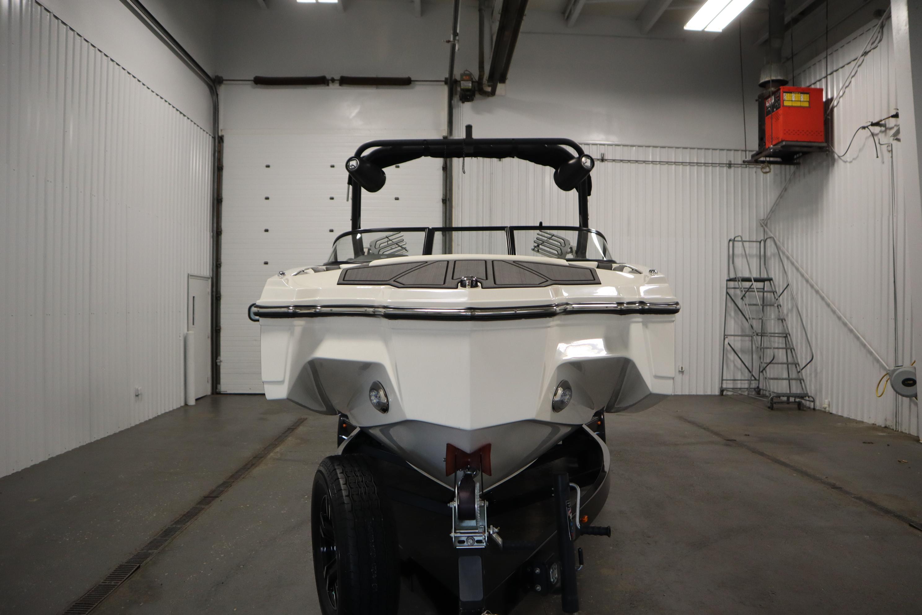 2023 Heyday WT Surf boat in a garage, rear view.