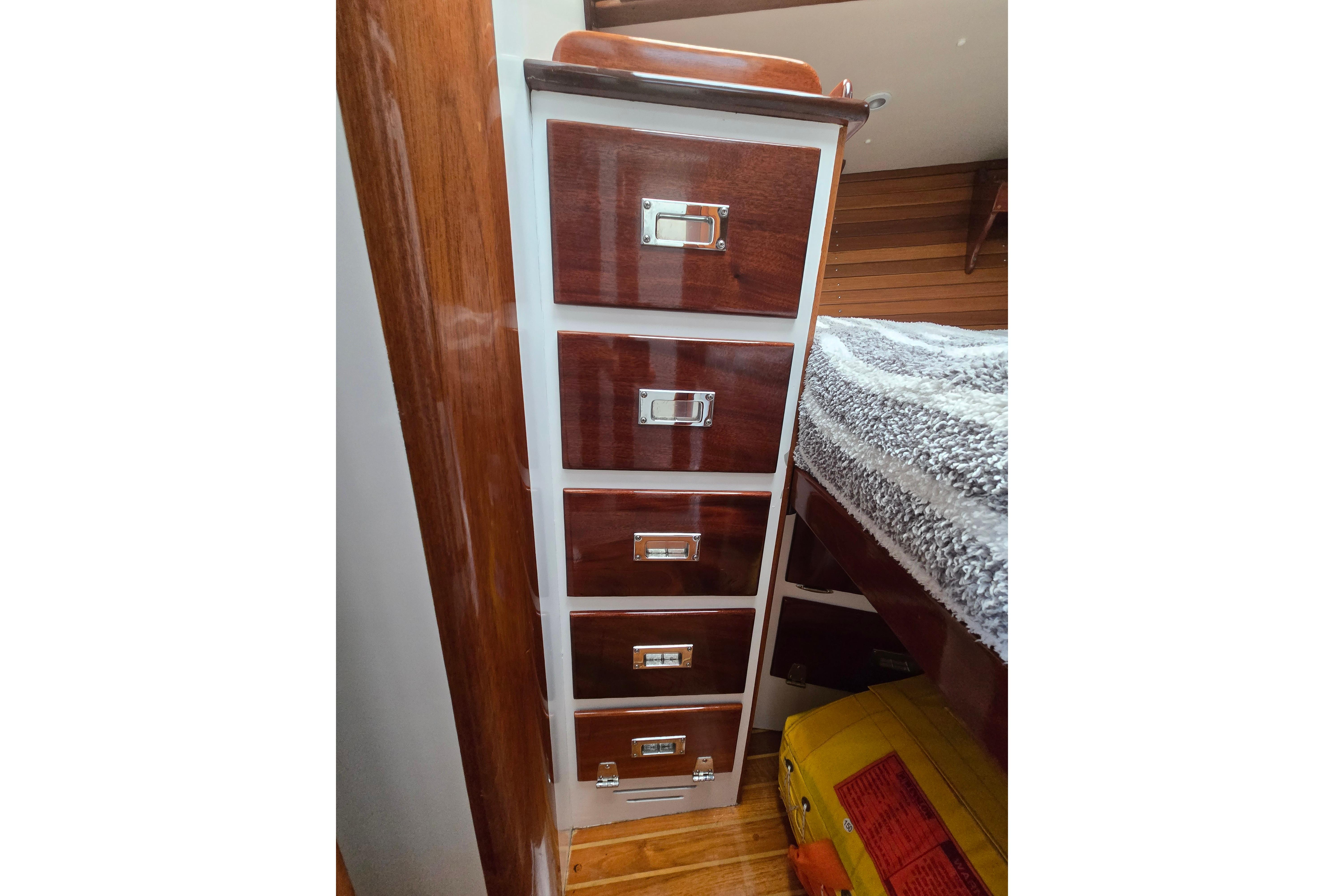 Wooden drawers inside a 1970 Hinckley Bermuda 40 yacht, showcasing classic nautical craftsmanship.