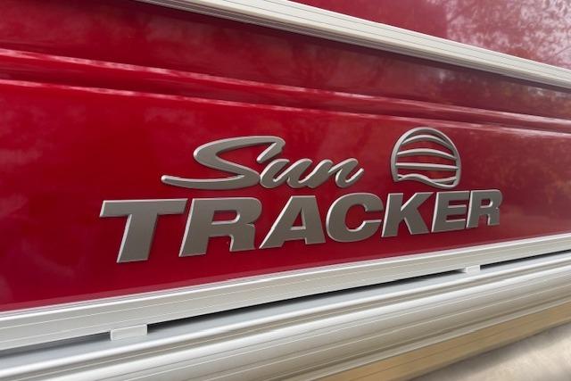 2026 Sun Tracker Party Barge 22 DLX logo on red exterior.