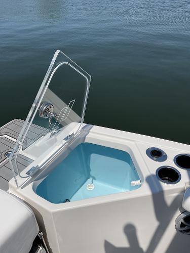 2025 Starcraft SVX 211 OB CC boat with open storage compartment on calm water.