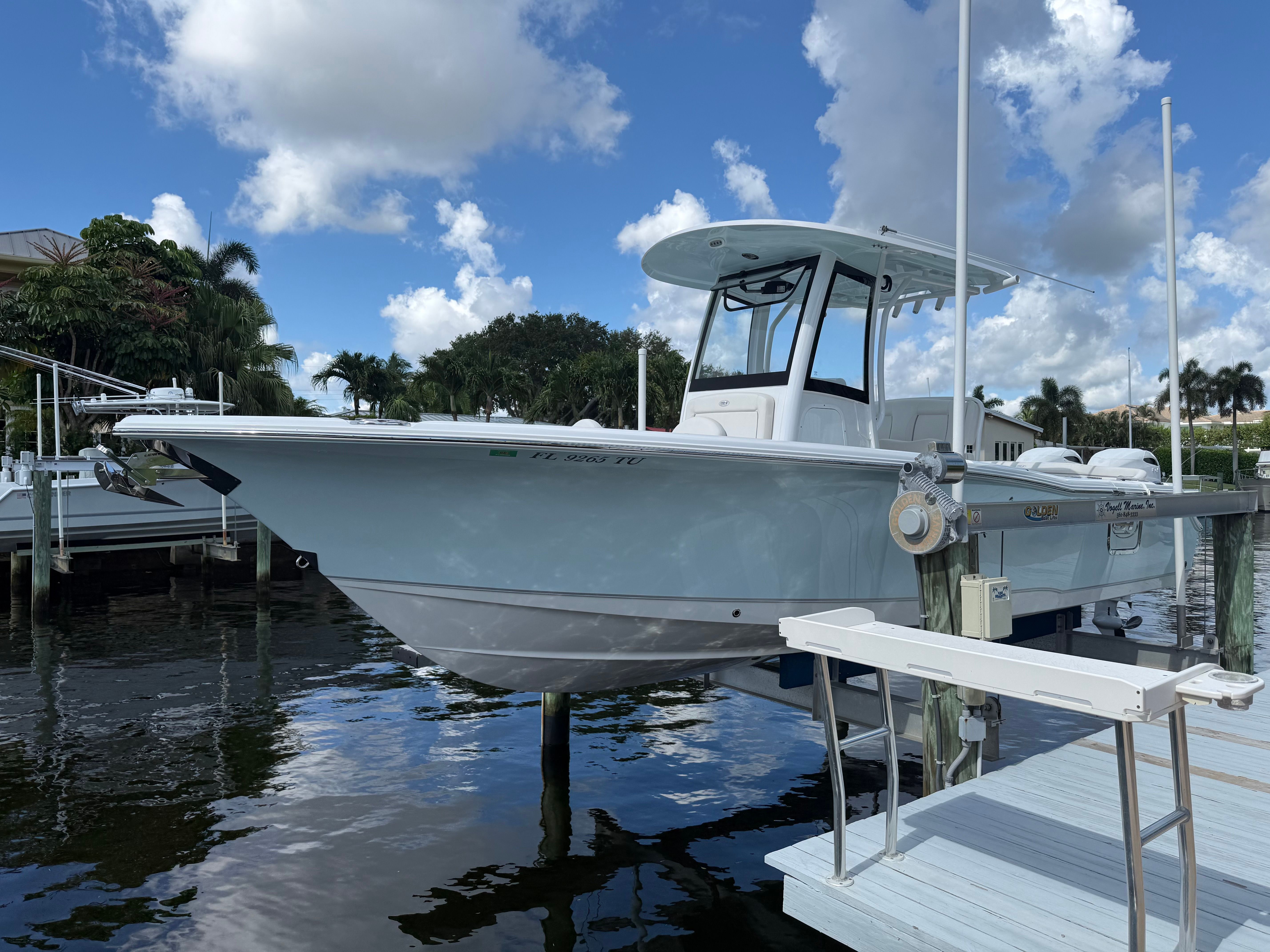 A 2024 Sea Hunt Ultra 265 SE boat docked on the water.