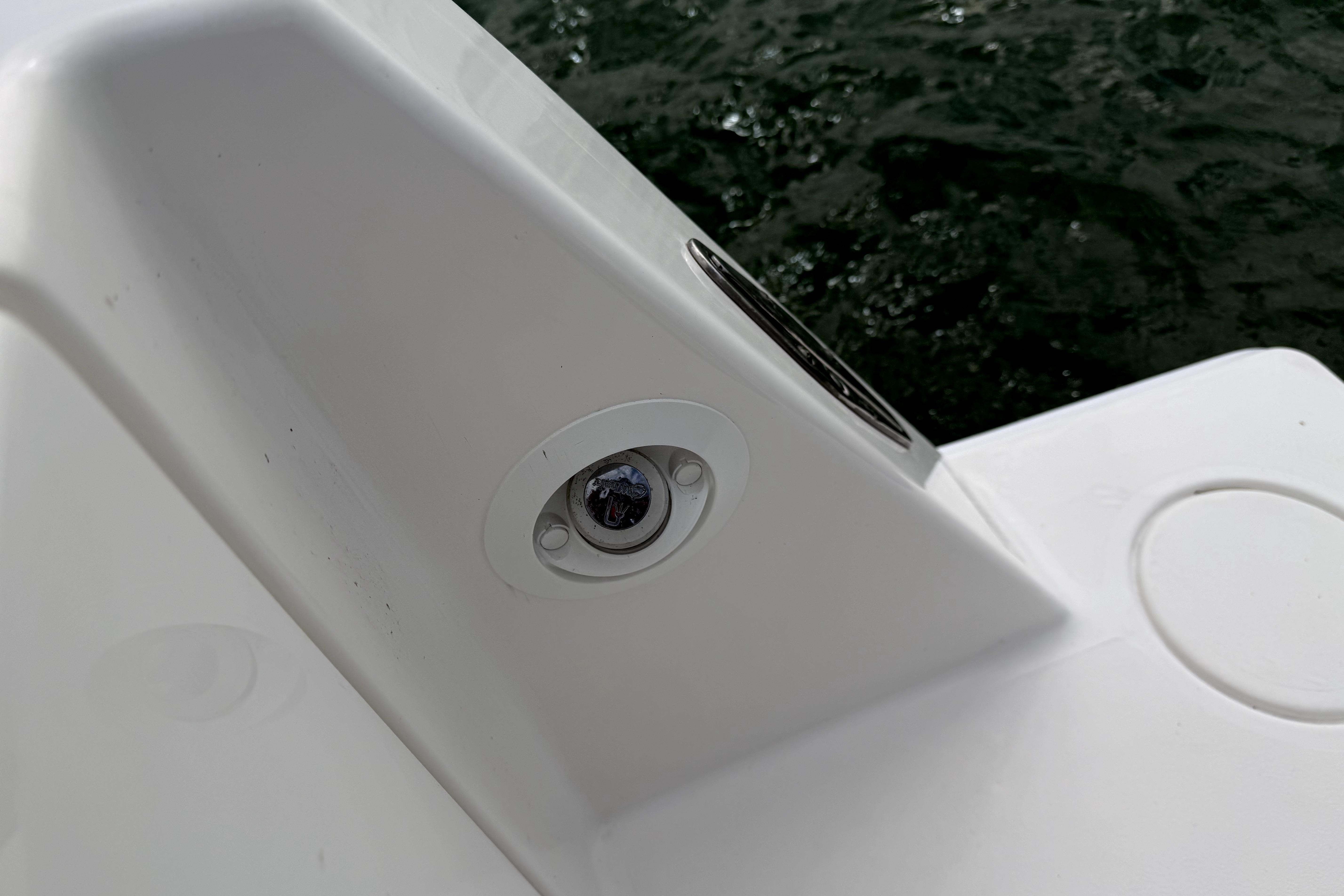 Close-up of a 2019 Contender 30 ST boat detail near water.